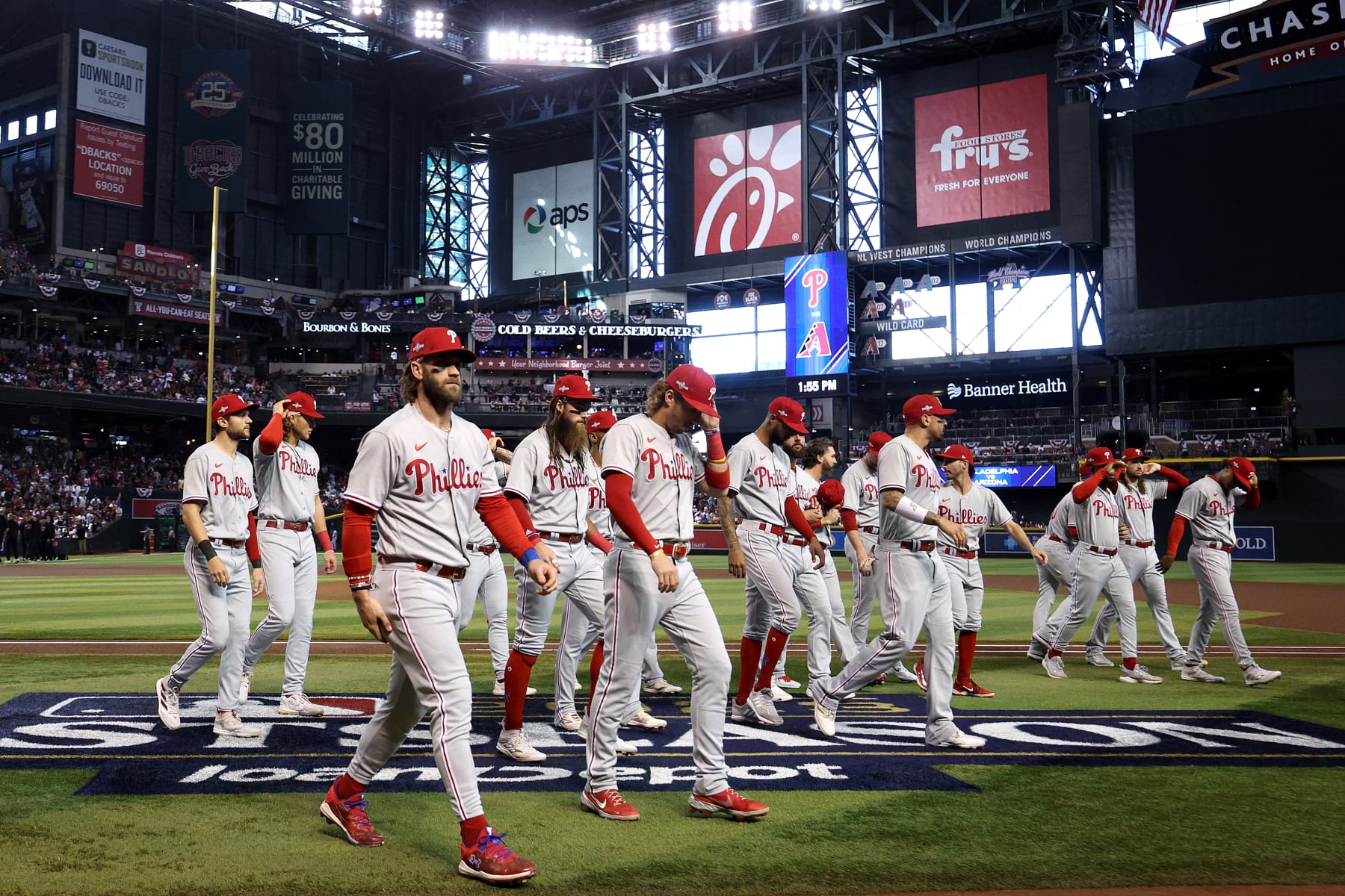 PHOENIX, ARIZONA - OCTOBER 19: Bryce Harper #3 of the Philadelphia Phillies walks to the dugout with his teammates prior to Game Three of the National League Championship Series against the Arizona Diamondbacks at Chase Field on October 19, 2023 in Phoenix, Arizona. (Photo by Harry How/Getty Images)