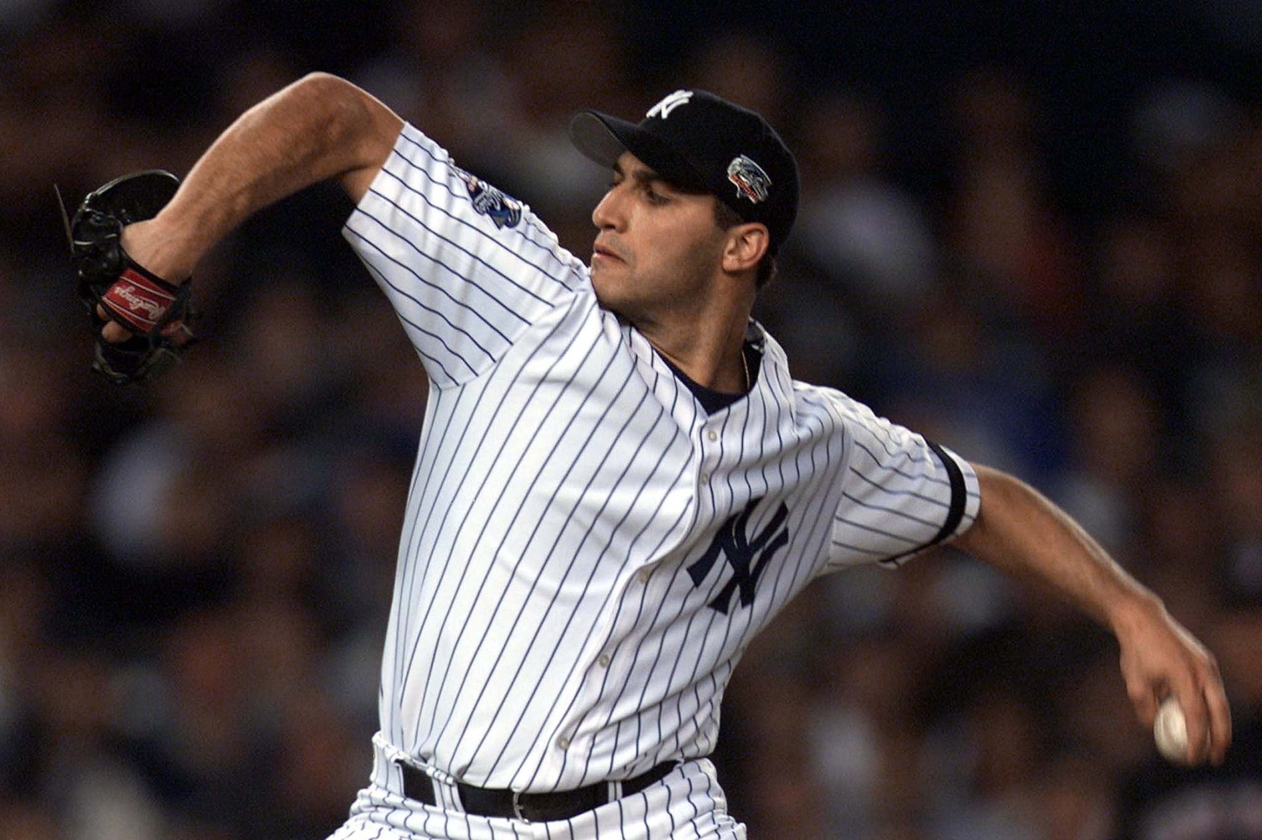 New York Yankee starting pitcher Andy Pettitte hurls against the New York Mets in the first inning of game one of the World Series at Yankee Stadium 21 October 2000 in New York, NY. This is the first time in 44 years that two New York teams have faced each other in the World Series.  AFP PHOTO/Jeff HAYNES (Photo by JEFF HAYNES / AFP) (Photo by JEFF HAYNES/AFP via Getty Images)