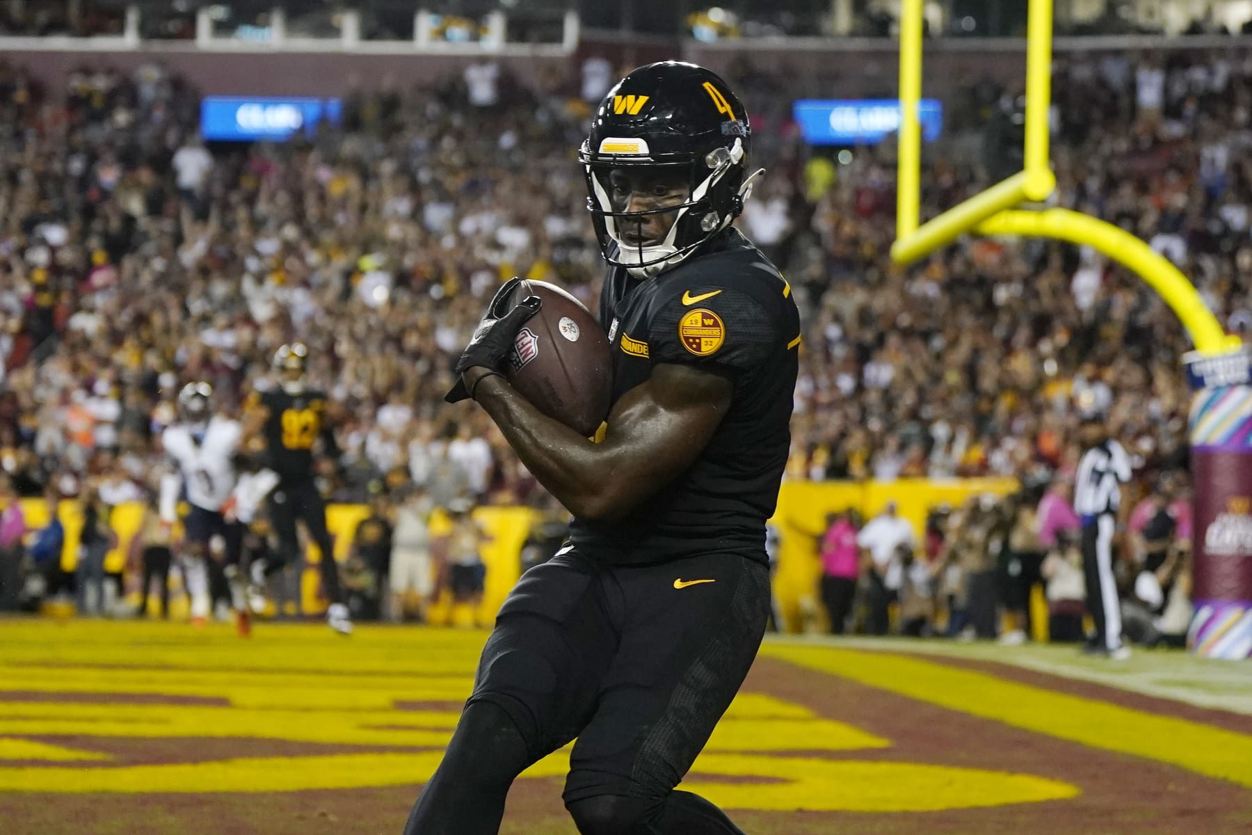 LANDOVER, MARYLAND - OCTOBER 05: Curtis Samuel #4 of the Washington Commanders scores a touchdown during the fourth quarter against the Chicago Bears at FedExField on October 05, 2023 in Landover, Maryland. (Photo by Jess Rapfogel/Getty Images)