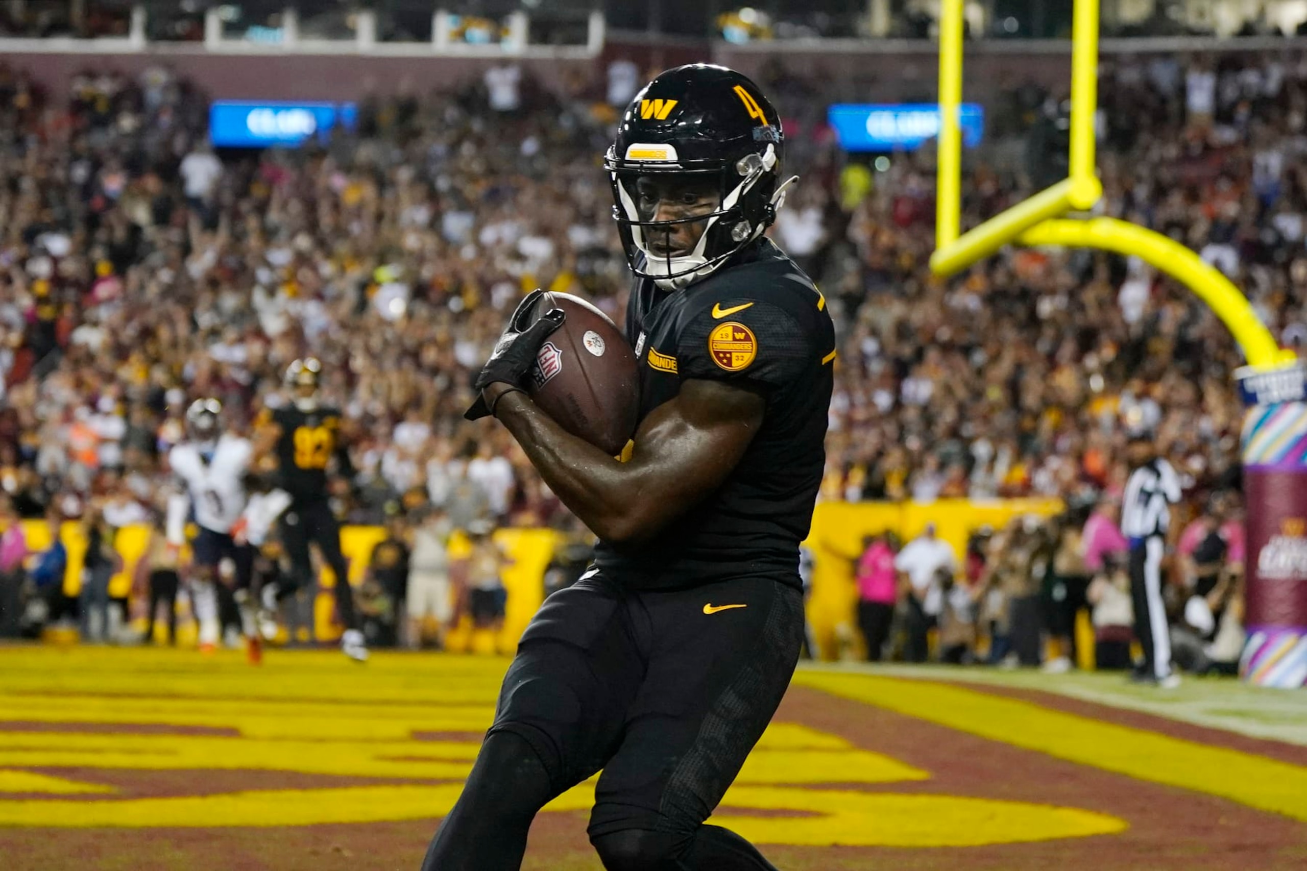 LANDOVER, MARYLAND - OCTOBER 05: Curtis Samuel #4 of the Washington Commanders scores a touchdown during the fourth quarter against the Chicago Bears at FedExField on October 05, 2023 in Landover, Maryland. (Photo by Jess Rapfogel/Getty Images)
