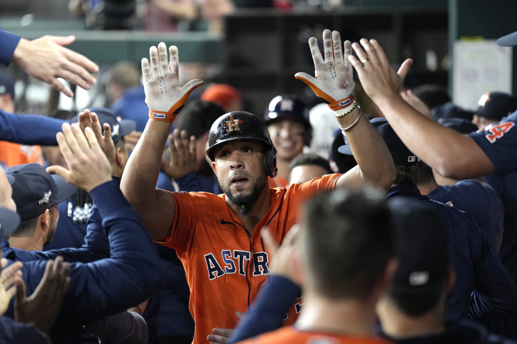 Houston Astros' Jose Abreu celebrates in the dugout aftr hitting a three-run home run against the Texas Rangers during the fourth inning in Game 4 of the baseball American League Championship Series Thursday, Oct. 19, 2023, in Arlington, Texas. (AP Photo/Godofredo A. Vasquez)