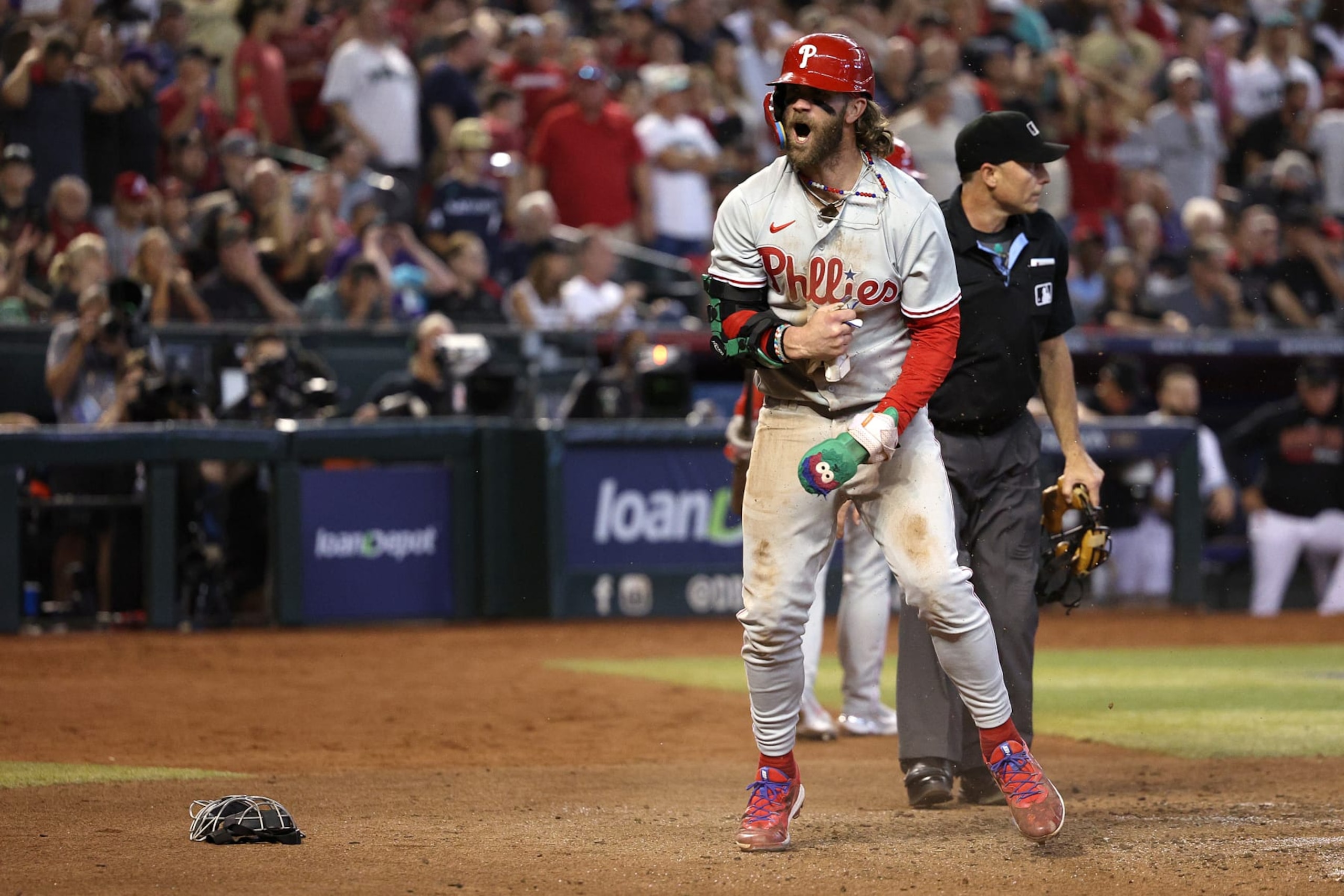 PHOENIX, ARIZONA - OCTOBER 19: Bryce Harper #3 of the Philadelphia Phillies celebrates after scoring a run off of a wild pitch thrown by Ryan Thompson #81 of the Arizona Diamondbacks during the seventh inning in Game Three of the National League Championship Series at Chase Field on October 19, 2023 in Phoenix, Arizona. (Photo by Harry How/Getty Images)