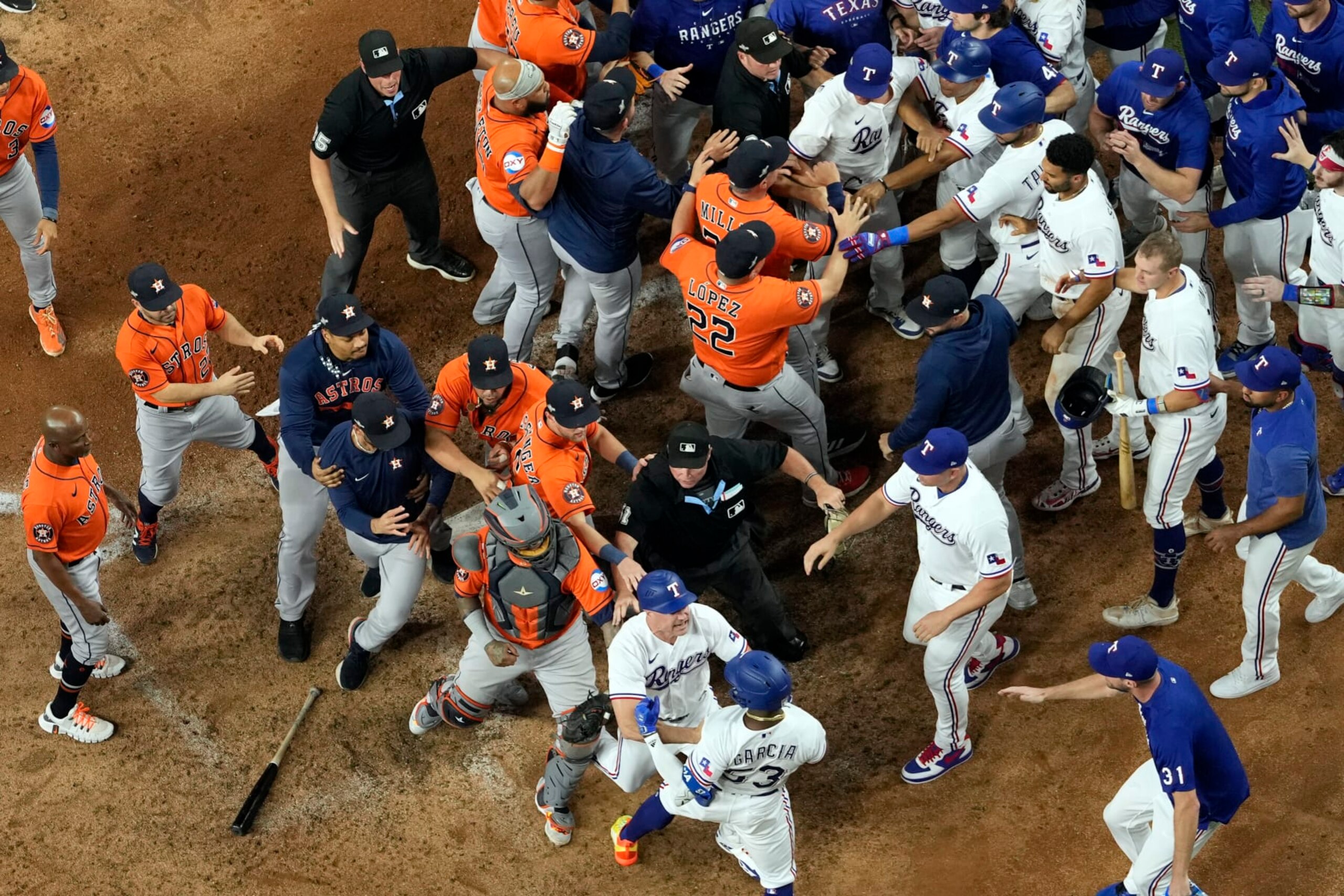 Players from Houston Astros and Texas Rangers clear the benches after Texas Rangers' Adolis Garcia was hit by a pitch thrown by Houston Astros relief pitcher Bryan Abreu during the eighth inning in Game 5 of the baseball American League Championship Series Friday, Oct. 20, 2023, in Arlington, Texas. (AP Photo/Godofredo A. Vásquez)