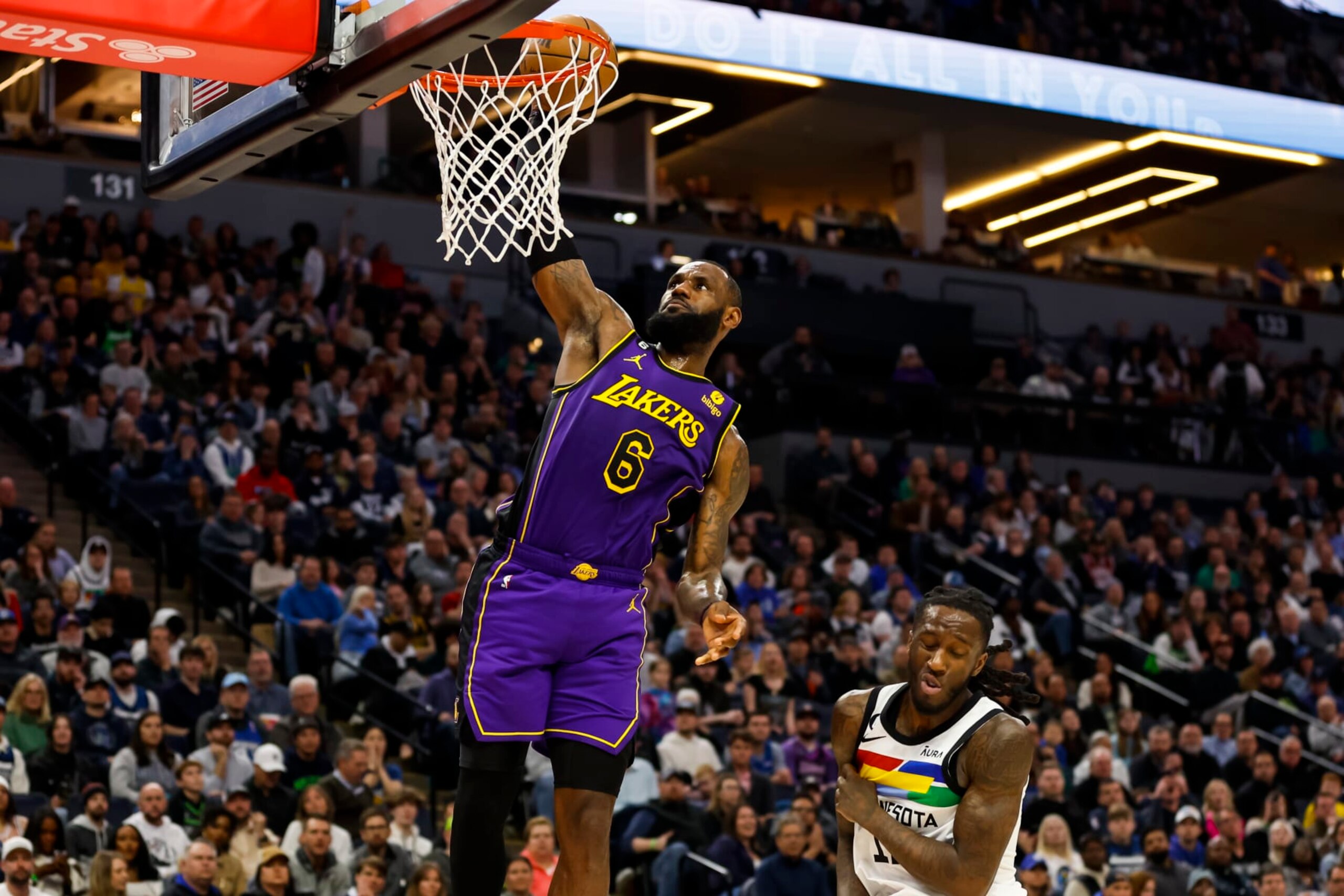 MINNEAPOLIS, MN - MARCH 31: LeBron James #6 of the Los Angeles Lakers dunks the ball as Taurean Prince #12 of the Minnesota Timberwolves reacts in the second quarter of the game at Target Center on March 31, 2023 in Minneapolis, Minnesota. NOTE TO USER: User expressly acknowledges and agrees that, by downloading and or using this Photograph, user is consenting to the terms and conditions of the Getty Images License Agreement. (Photo by David Berding/Getty Images)