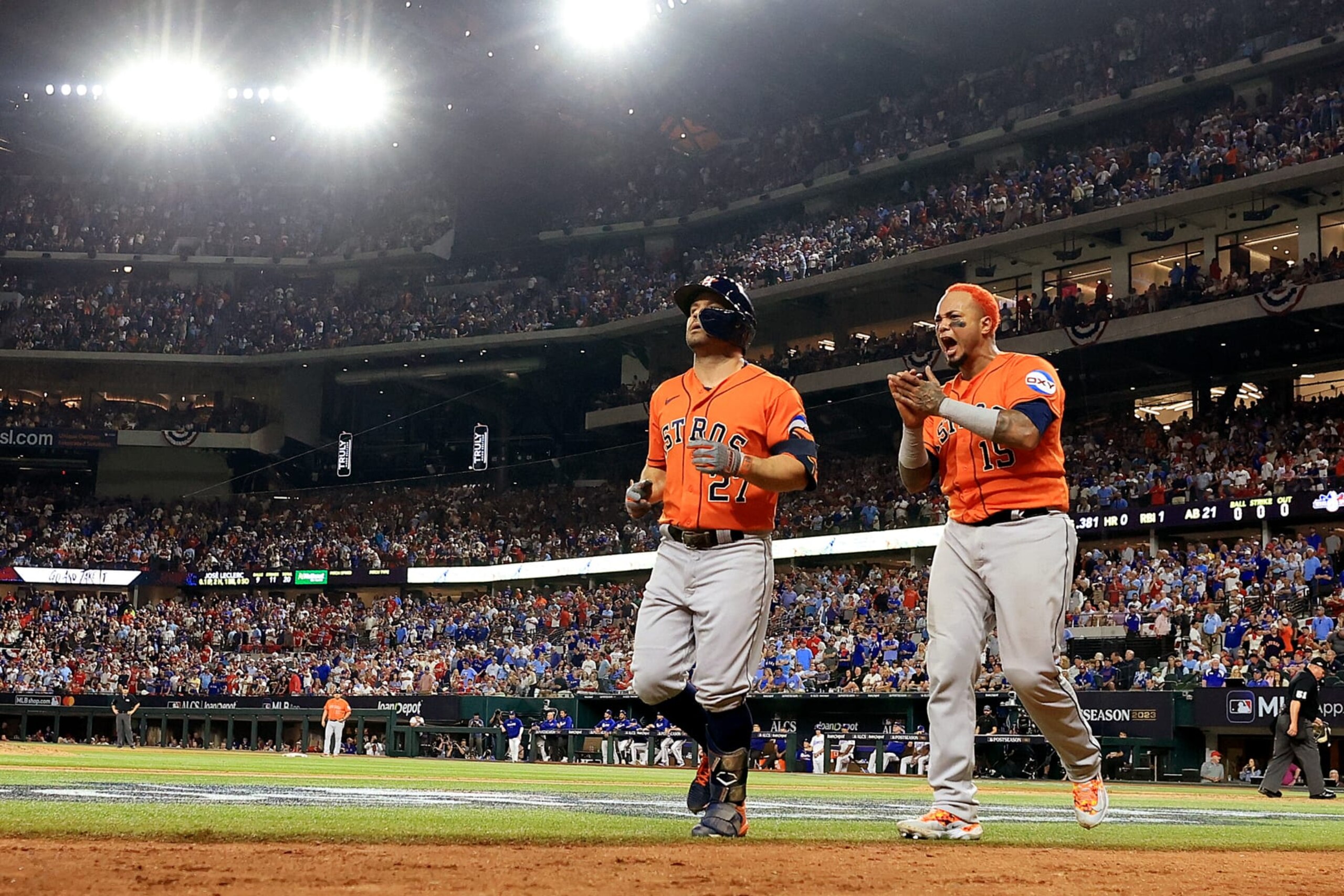 ARLINGTON, TEXAS - OCTOBER 20: Jose Altuve #27 of the Houston Astros celebrates with Martin Maldonado #15 after hitting a three run home run against Jose Leclerc #25 of the Texas Rangers during the ninth inning in Game Five of the American League Championship Series at Globe Life Field on October 20, 2023 in Arlington, Texas. (Photo by Carmen Mandato/Getty Images)