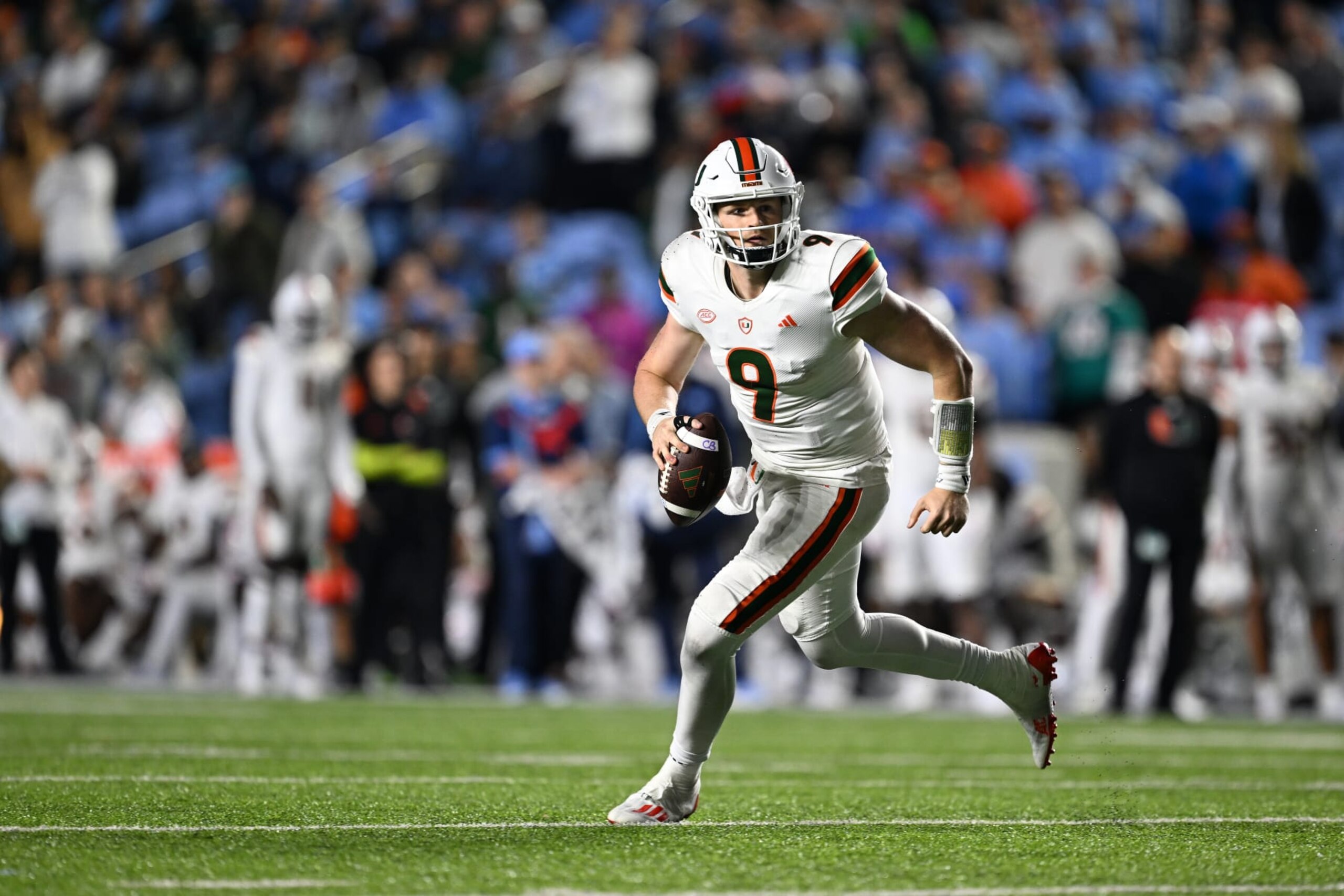 CHAPEL HILL, NORTH CAROLINA - OCTOBER 14: Tyler Van Dyke #9 of the Miami Hurricanes rolls out against the North Carolina Tar Heels during their game at Kenan Memorial Stadium on October 14, 2023 in Chapel Hill, North Carolina. The Tar Heels won 41-31. (Photo by Grant Halverson/Getty Images)