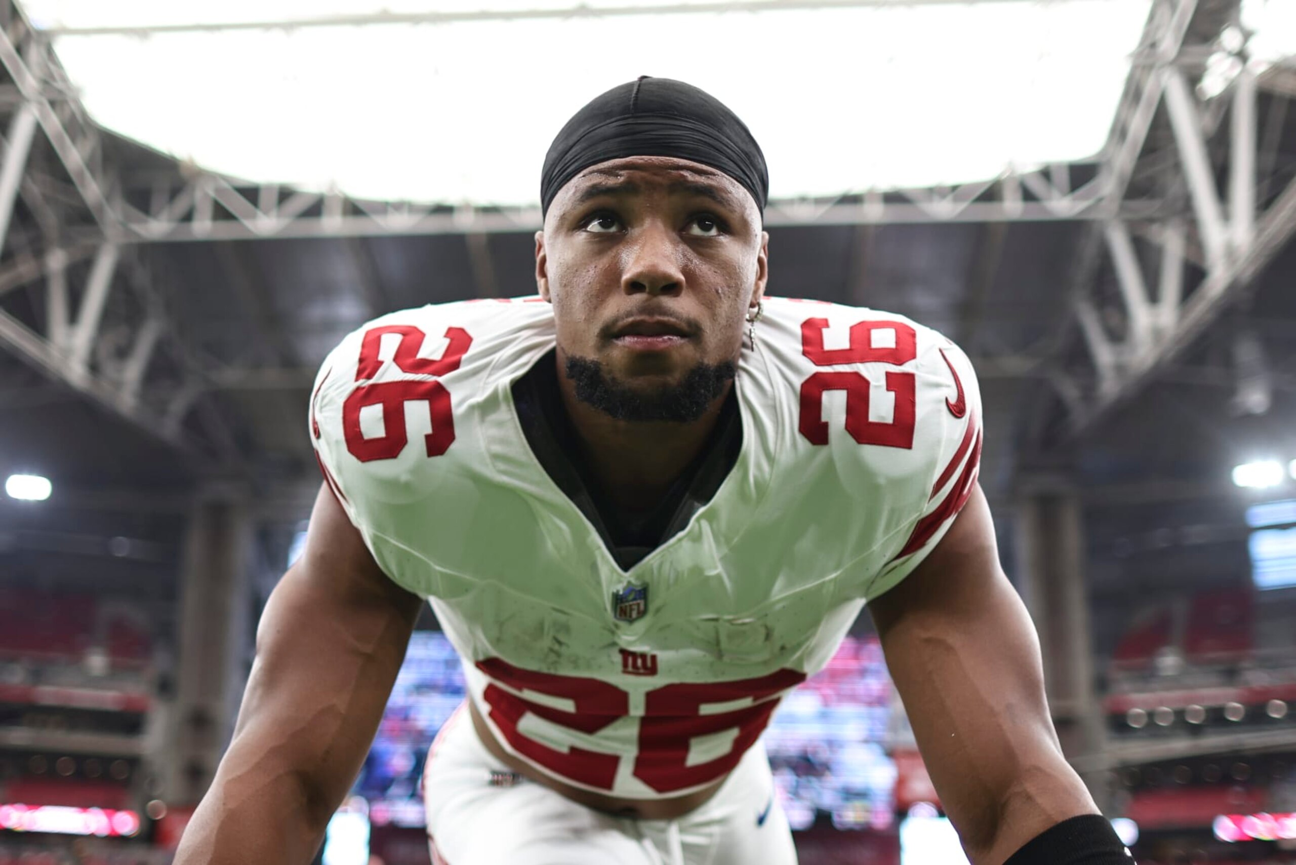 GLENDALE, ARIZONA - SEPTEMBER 17: Saquon Barkley #26 of the New York Giants looks on as he stretches prior to an NFL football game between the Arizona Cardinals and the New York Giants at State Farm Stadium on September 17, 2023 in Glendale, Arizona. (Photo by Michael Owens/Getty Images)