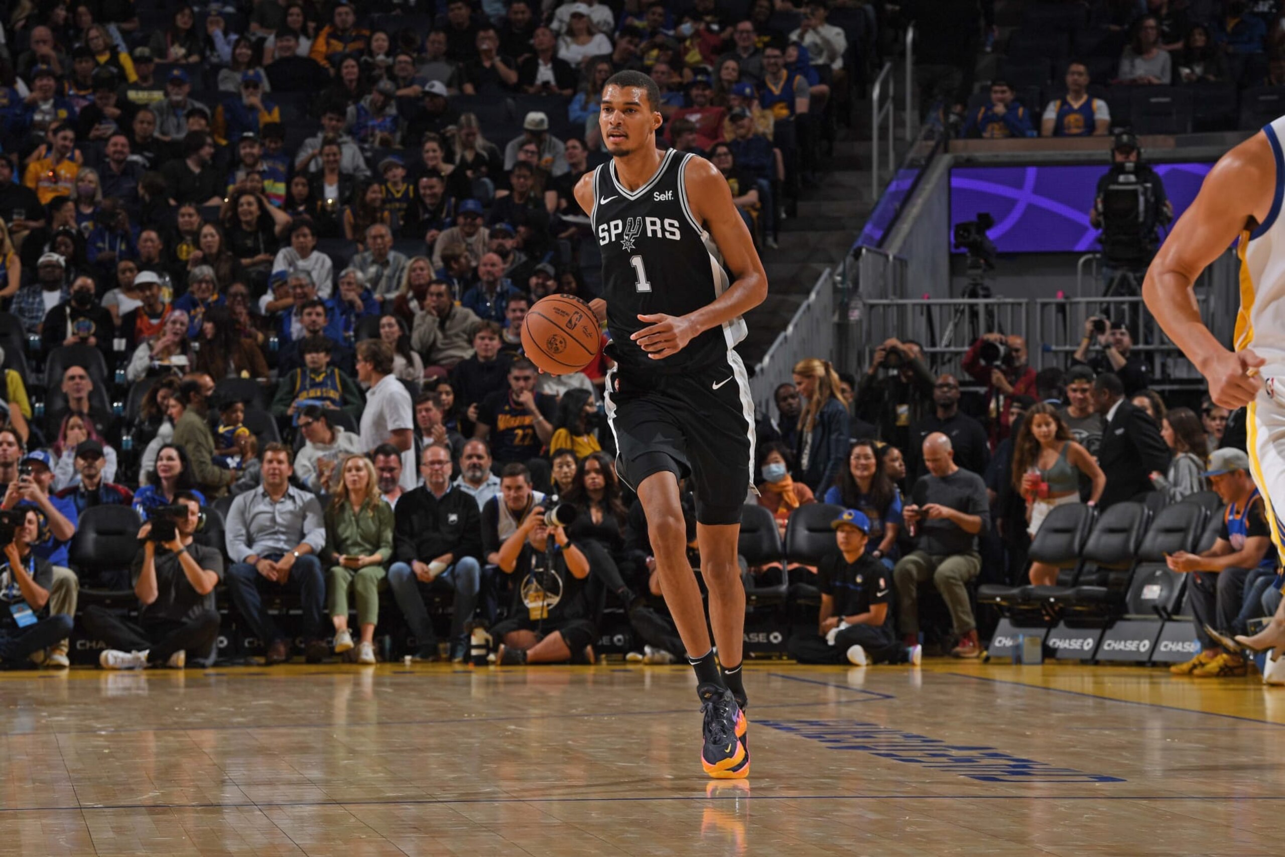 SAN FRANCISCO, CA - OCTOBER 20: Victor Wembanyama #1 of the San Antonio Spurs dribbles the ball during the game against the Golden State Warriors on October 20, 2023 at Chase Center in San Francisco, California. NOTE TO USER: User expressly acknowledges and agrees that, by downloading and or using this photograph, user is consenting to the terms and conditions of Getty Images License Agreement. Mandatory Copyright Notice: Copyright 2023 NBAE (Photo by Noah Graham/NBAE via Getty Images) SAN FRANCISCO, CA - OCTOBER 20: Victor Wembanyama #1 of the San Antonio Spurs dribbles the ball during the game against the Golden State Warriors on October 20, 2023 at Chase Center in San Francisco, California. NOTE TO USER: User expressly acknowledges and agrees that, by downloading and or using this photograph, user is consenting to the terms and conditions of Getty Images License Agreement. Mandatory Copyright Notice: Copyright 2023 NBAE (Photo by Noah Graham/NBAE via Getty Images)