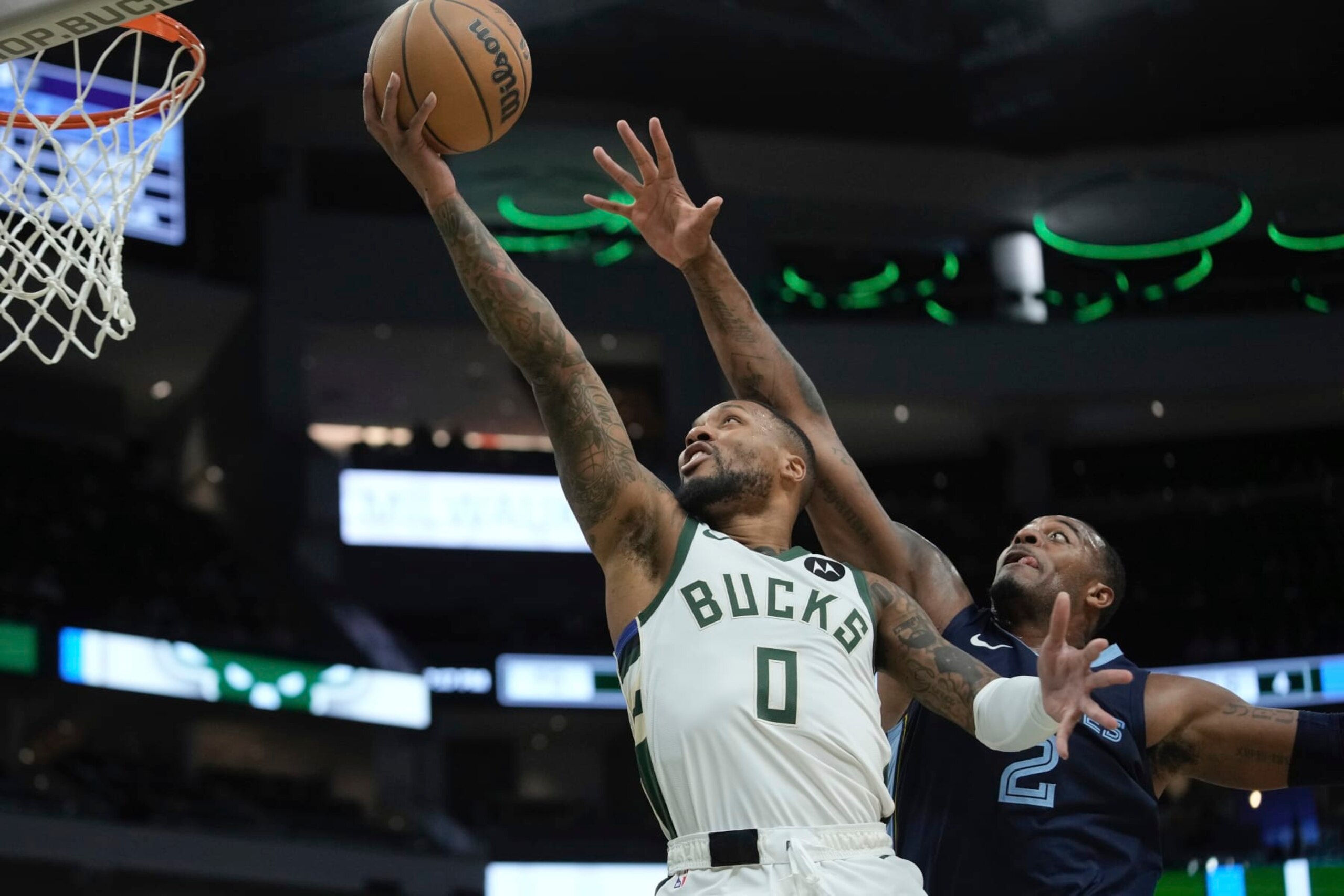 Milwaukee Bucks' Damian Lillard shoots past Memphis Grizzlies' Xavier Tillman during the first half of a preseason NBA basketball game Friday, Oct. 20, 2023, in Milwaukee. (AP Photo/Morry Gash)