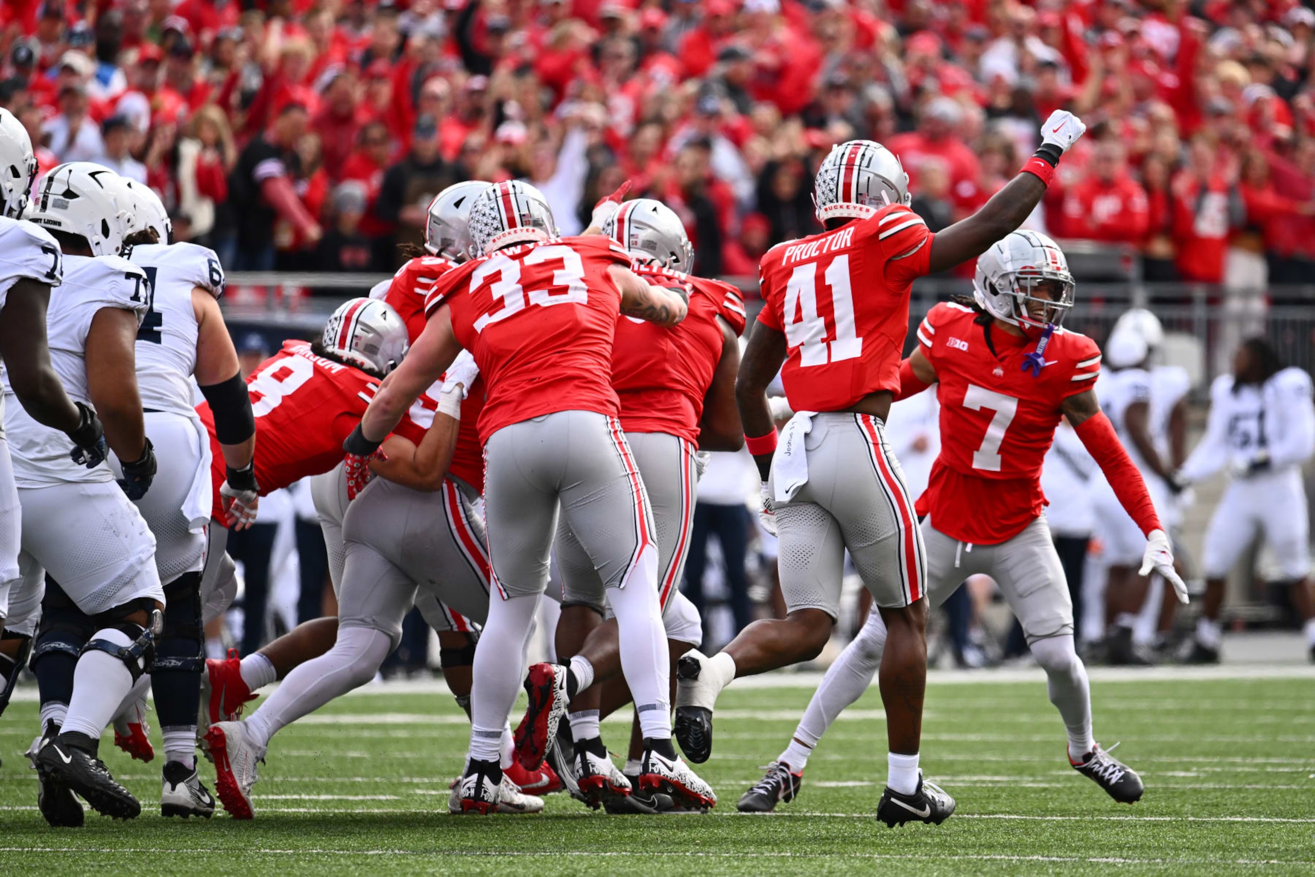 COLUMBUS, OHIO - OCTOBER 21: Josh Proctor #41 of the Ohio State Buckeyes signals for fourth down after the Ohio State Buckeyes make a stop against the Penn State Nittany Lions in the second quarter of a game at Ohio Stadium on October 21, 2023 in Columbus, Ohio. (Photo by Ben Jackson/Getty Images)