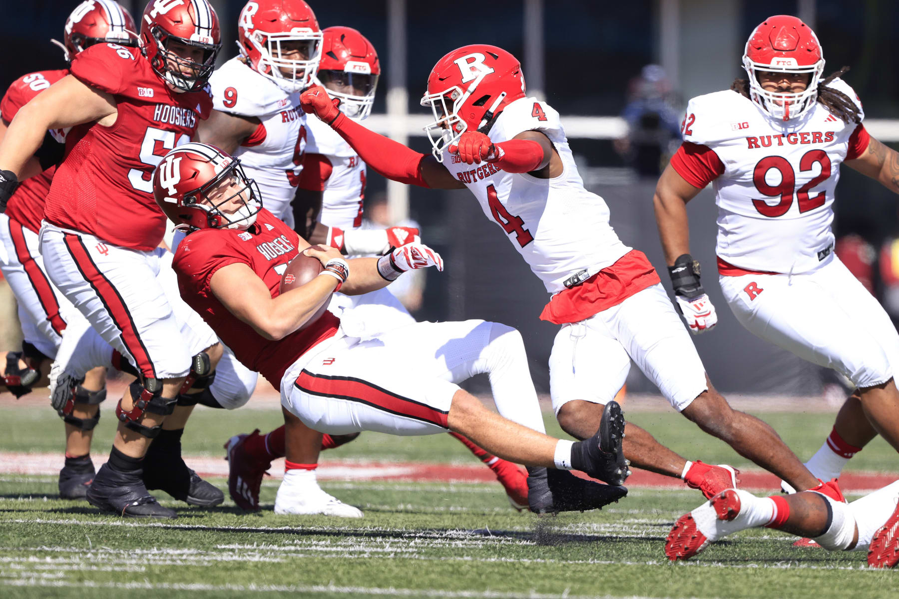 BLOOMINGTON, INDIANA - OCTOBER 21: Brendan Sorsby #15 of the Indiana Hoosiers is hit by Desmond Igbinosun #4 of the Rutgers Scarlet Knights during the first half at Memorial Stadium on October 21, 2023 in Bloomington, Indiana. (Photo by Justin Casterline/Getty Images)
