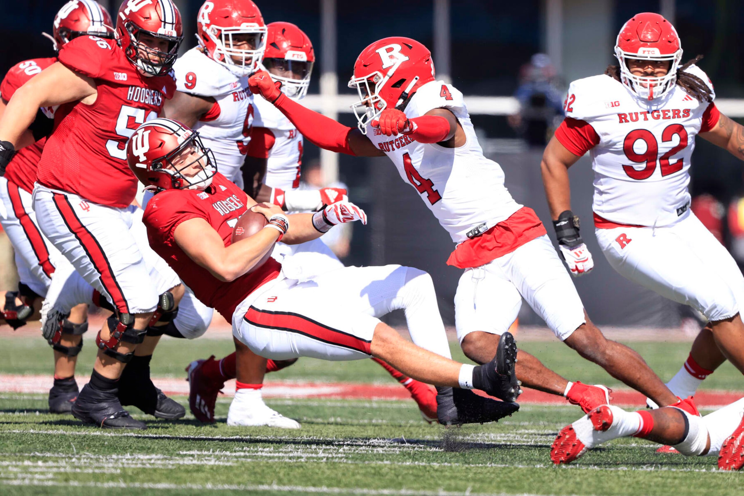 BLOOMINGTON, INDIANA - OCTOBER 21: Brendan Sorsby #15 of the Indiana Hoosiers is hit by Desmond Igbinosun #4 of the Rutgers Scarlet Knights during the first half at Memorial Stadium on October 21, 2023 in Bloomington, Indiana. (Photo by Justin Casterline/Getty Images)