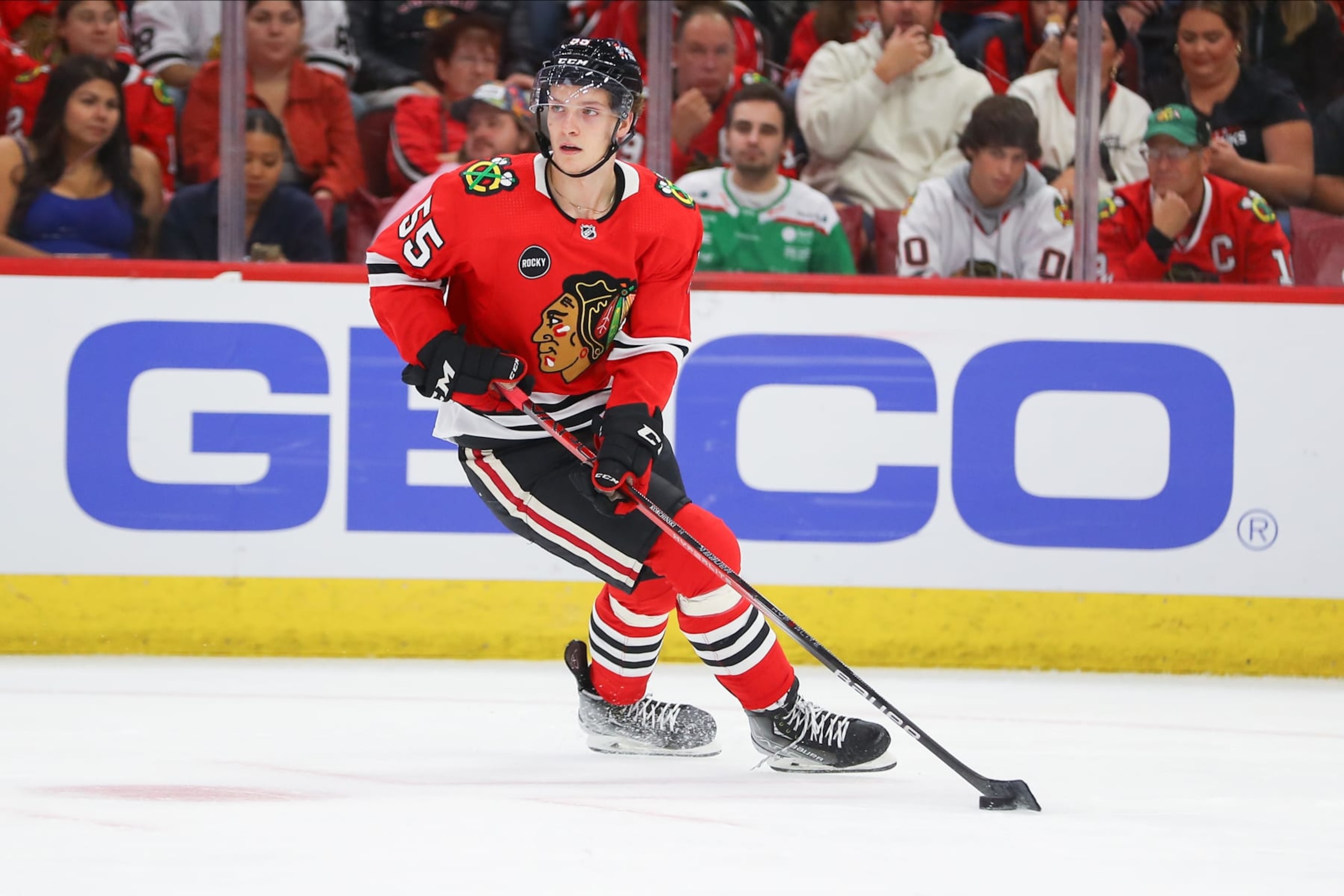 CHICAGO, IL - OCTOBER 03: Chicago Blackhawks defenseman Kevin Korchinski (55) controls the puck during a game between the Detroit Red Wings and the Chicago Blackhawks on October 3, 2023 at the United Center in Chicago, IL. (Photo by Melissa Tamez/Icon Sportswire via Getty Images)