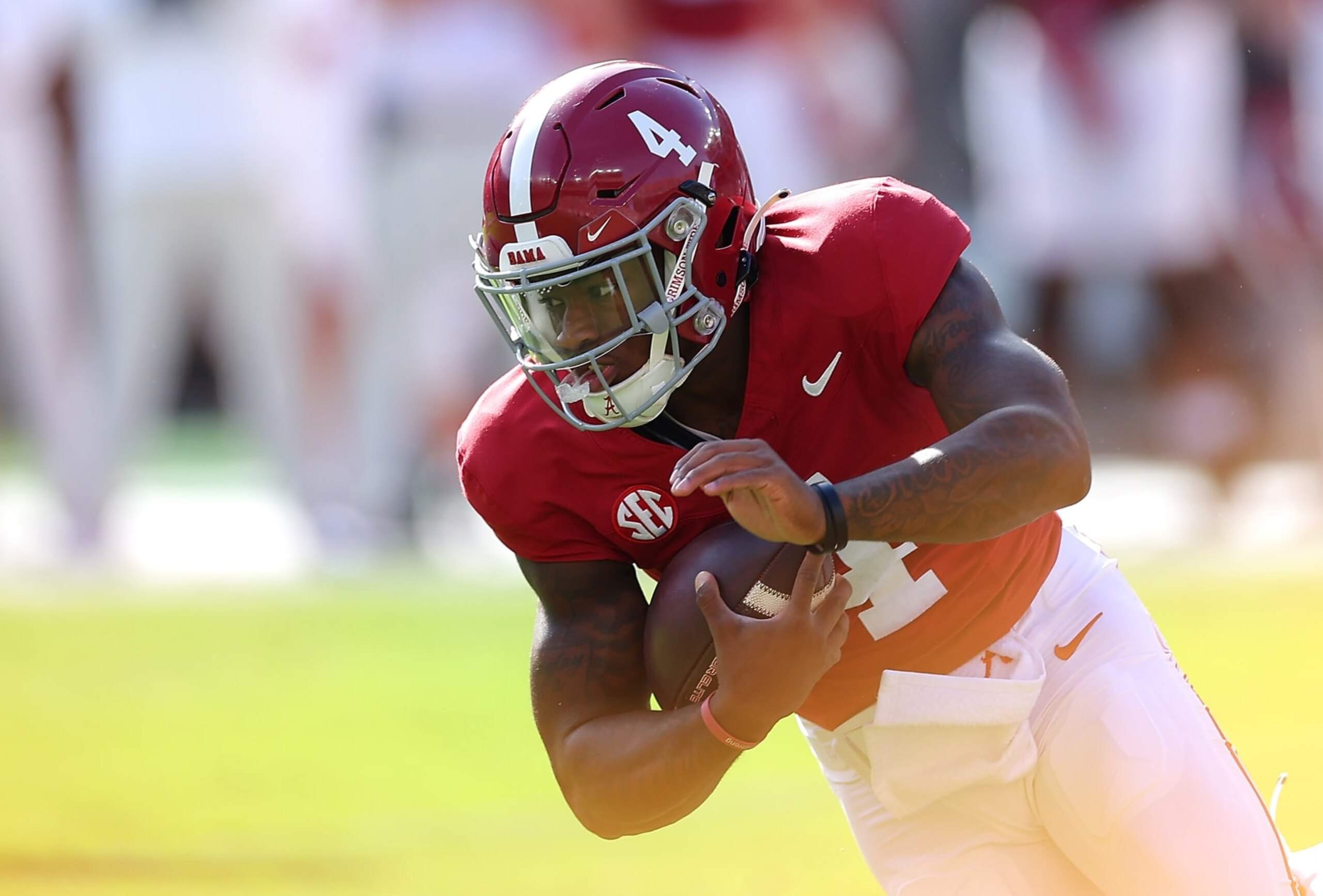 TUSCALOOSA, ALABAMA - OCTOBER 21:   Jalen Milroe #4 of the Alabama Crimson Tide is tackled as he rushes against the Tennessee Volunteers during the first quarter at Bryant-Denny Stadium on October 21, 2023 in Tuscaloosa, Alabama. (Photo by Kevin C. Cox/Getty Images)