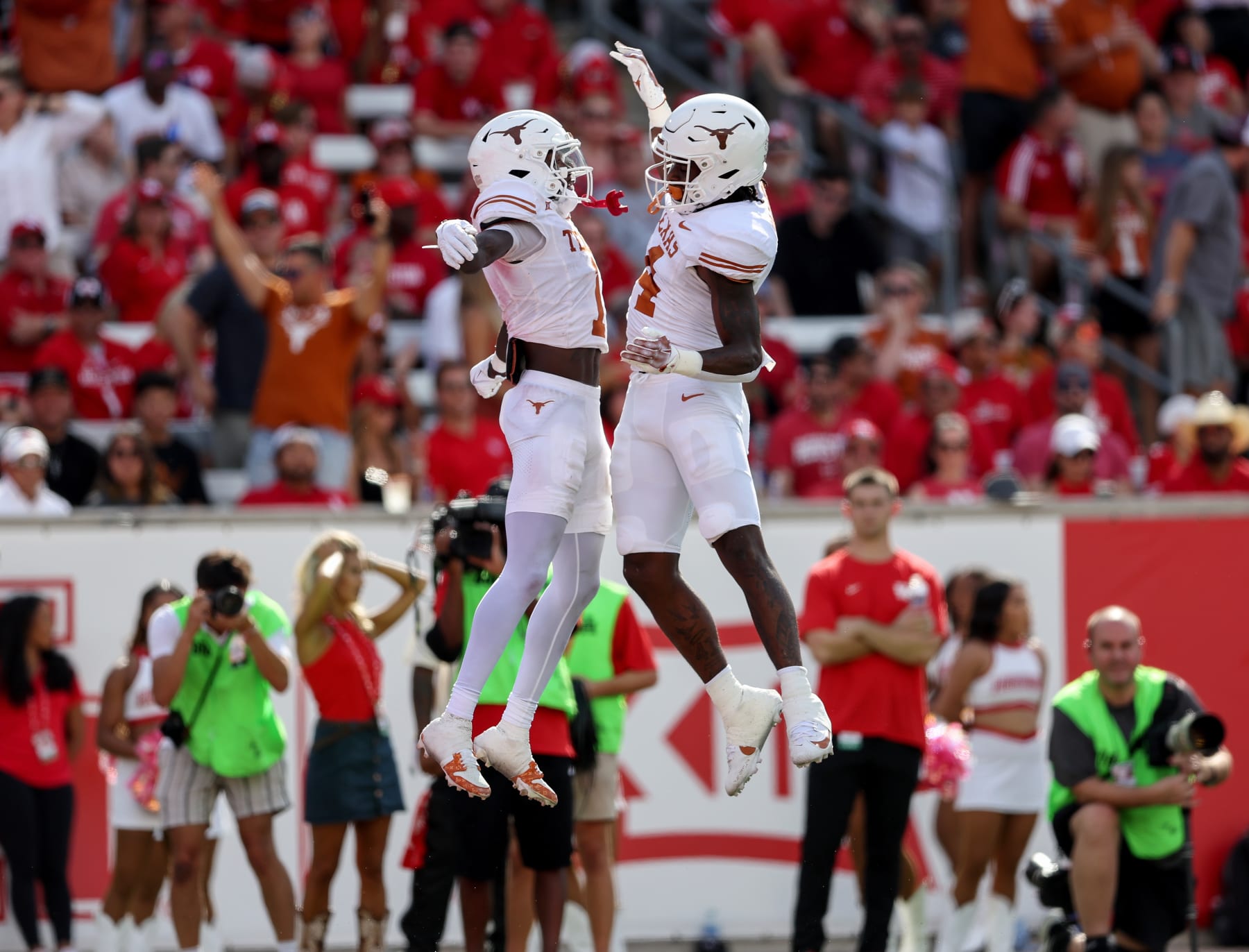 HOUSTON, TEXAS - OCTOBER 21: CJ Baxter #4 of the Texas Longhorns celebrates with Xavier Worthy #1 of the Texas Longhorns after a touchdown in the first quarter against the Houston Cougars at TDECU Stadium on October 21, 2023 in Houston, Texas. (Photo by Tim Warner/Getty Images)