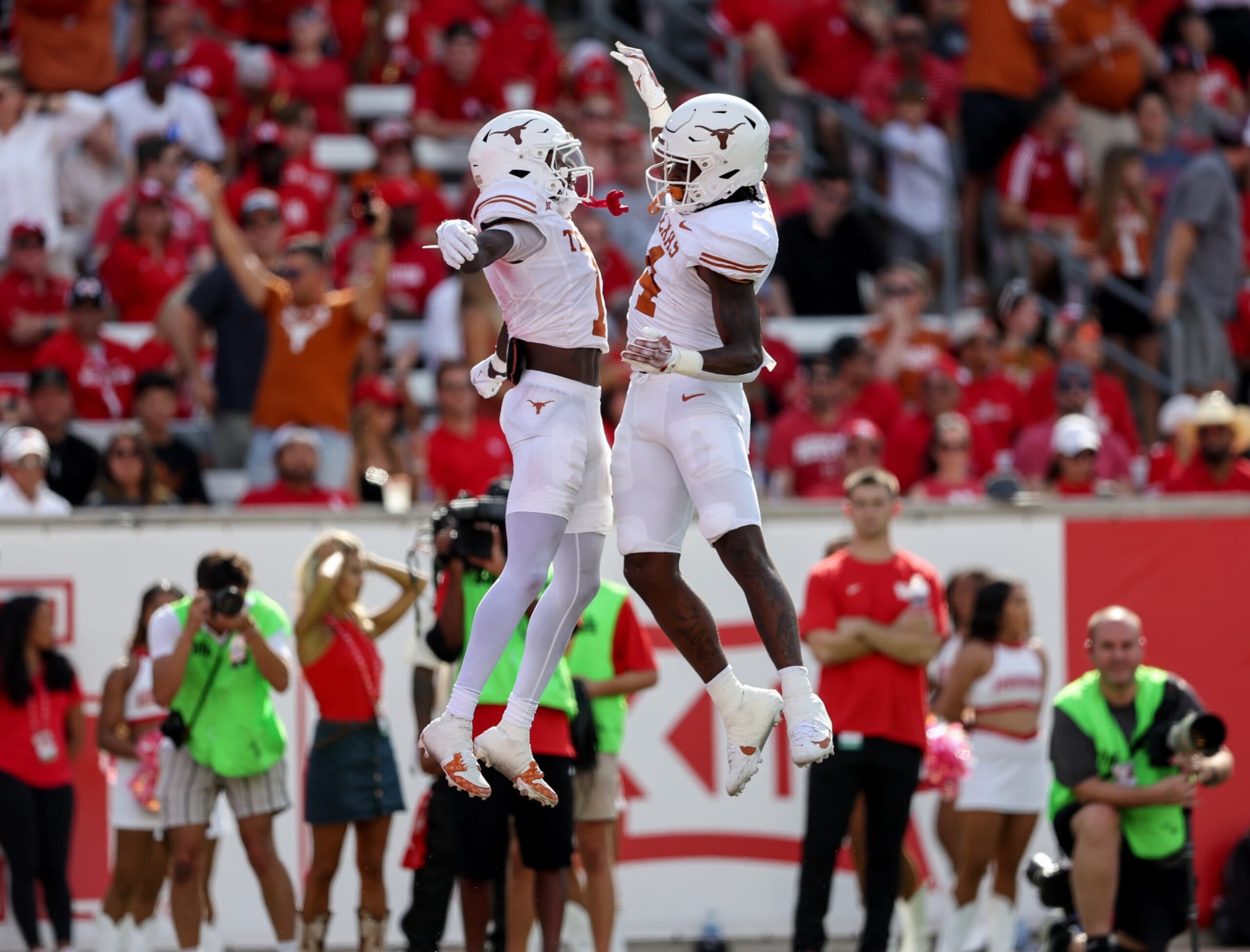 HOUSTON, TEXAS - OCTOBER 21: CJ Baxter #4 of the Texas Longhorns celebrates with Xavier Worthy #1 of the Texas Longhorns after a touchdown in the first quarter against the Houston Cougars at TDECU Stadium on October 21, 2023 in Houston, Texas. (Photo by Tim Warner/Getty Images)
