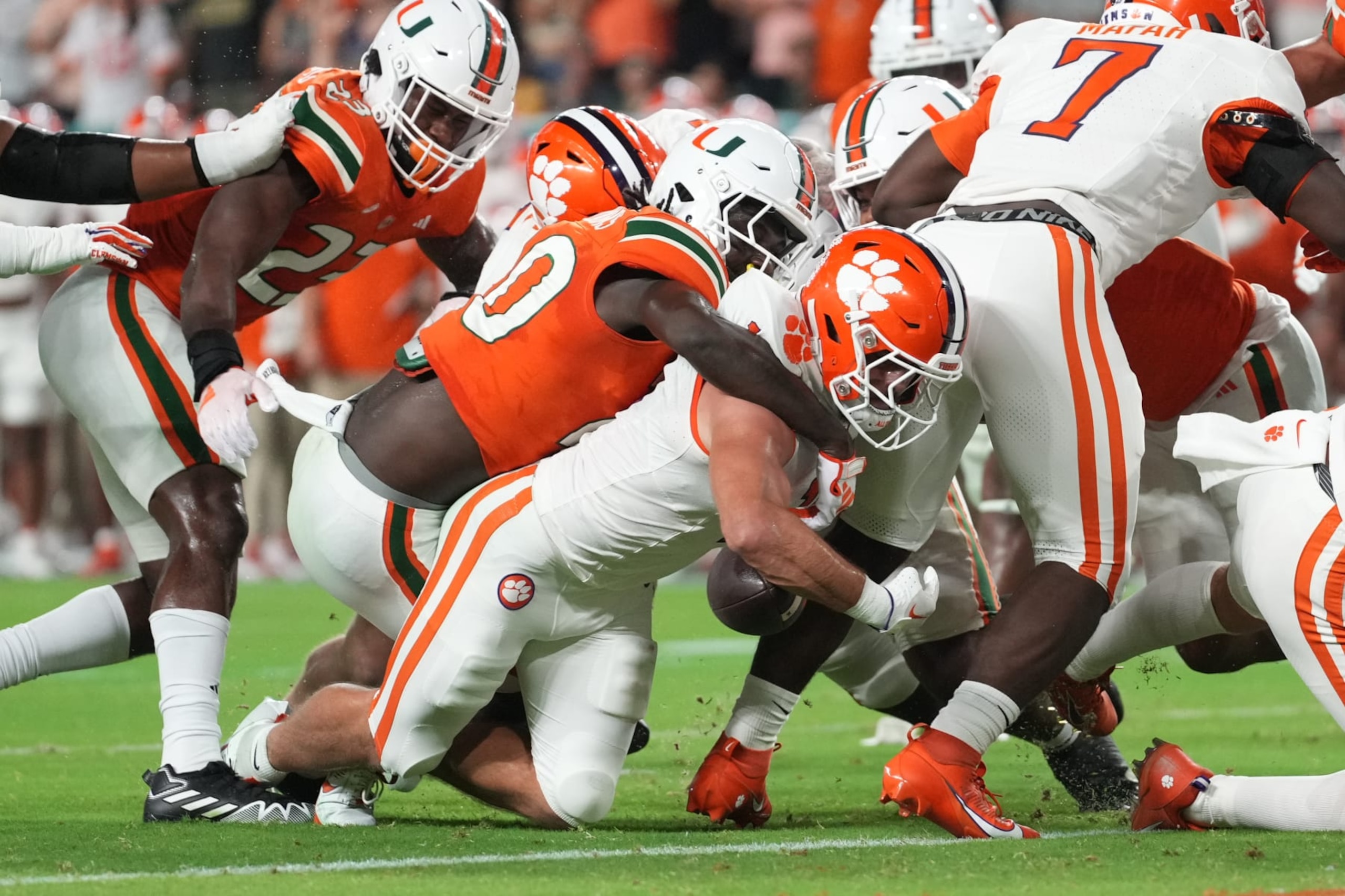 MIAMI GARDENS, FL - OCTOBER 21: Clemson Tigers running back Will Shipley (1) fumbles the ball before breaking the end zone plane after being hit byMiami Hurricanes safety James Williams (20) in the first half during the game between the Clemson Tigers and the Miami Hurricanes on Saturday, October 21, 2023 at Hard Rock Stadium, Miami Gardens, Fla. (Photo by Peter Joneleit/Icon Sportswire via Getty Images)