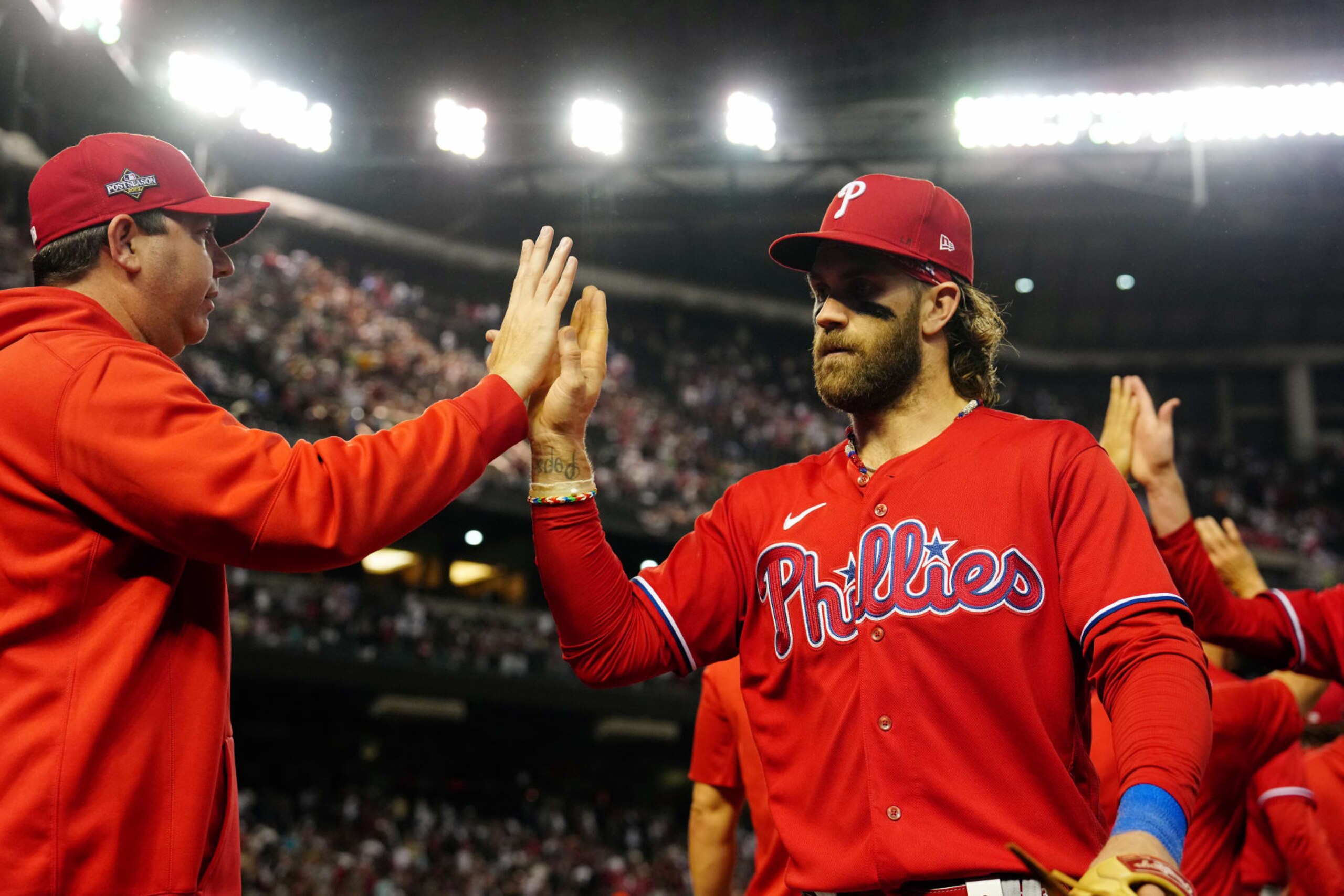 PHOENIX, AZ - OCTOBER 21: Bryce Harper #3 of the Philadelphia Phillies celebrates with teammates after the Phillies defeated the Arizona Diamondbacks in Game 5 of the NLCS at Chase Field on Saturday, October 21, 2023 in Phoenix, Arizona. (Photo by Mary DeCicco/MLB Photos via Getty Images) PHOENIX, AZ - OCTOBER 21: Bryce Harper #3 of the Philadelphia Phillies celebrates with teammates after the Phillies defeated the Arizona Diamondbacks in Game 5 of the NLCS at Chase Field on Saturday, October 21, 2023 in Phoenix, Arizona. (Photo by Mary DeCicco/MLB Photos via Getty Images)