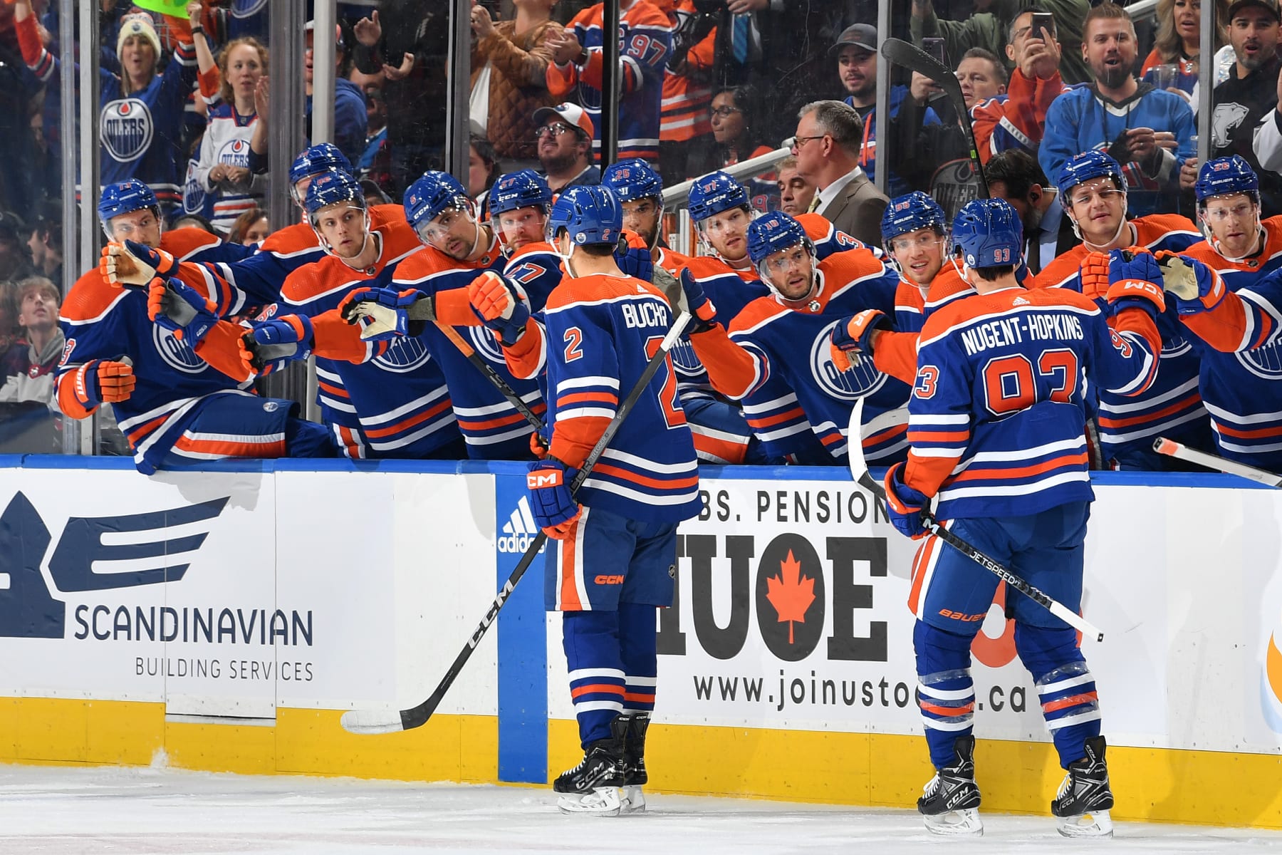 EDMONTON, CANADA - OCTOBER 21: Evan Bouchard #2 of the Edmonton Oilers celebrates with Ryan Nugent-Hopkins #93 at the bench with his teammates after his first period goal against the Winnipeg Jets during the game at Rogers Place on October 21, 2023, in Edmonton, Alberta, Canada. (Photo by Andy Devlin/NHLI via Getty Images)