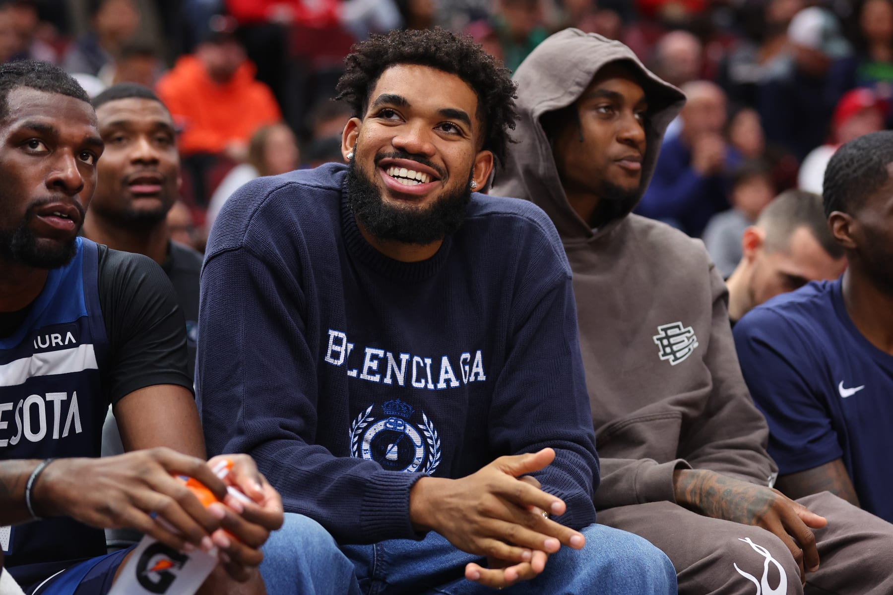 CHICAGO, ILLINOIS - OCTOBER 19: Karl-Anthony Towns #32 of the Minnesota Timberwolves laughs on the bench against the Chicago Bulls during the second half of a preseason game at the United Center on October 19, 2023 in Chicago, Illinois. NOTE TO USER: User expressly acknowledges and agrees that, by downloading and or using this photograph, User is consenting to the terms and conditions of the Getty Images License Agreement.  (Photo by Michael Reaves/Getty Images)