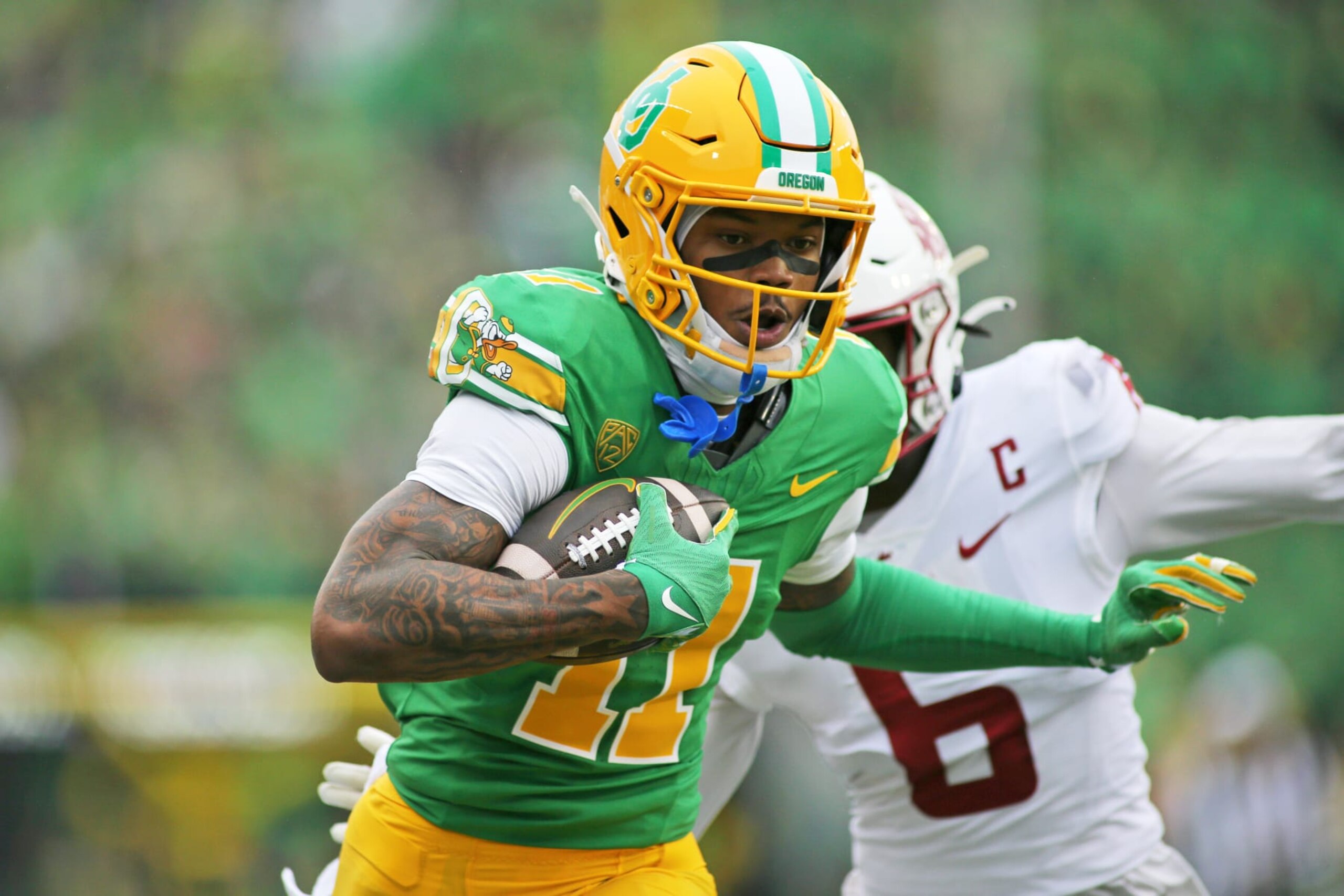 EUGENE, OREGON - OCTOBER 21: Troy Franklin #11 of the Oregon Ducks runs with the ball in the second half against the Washington State Cougars at Autzen Stadium on October 21, 2023 in Eugene, Oregon. (Photo by Lydia Ely/Getty Images)