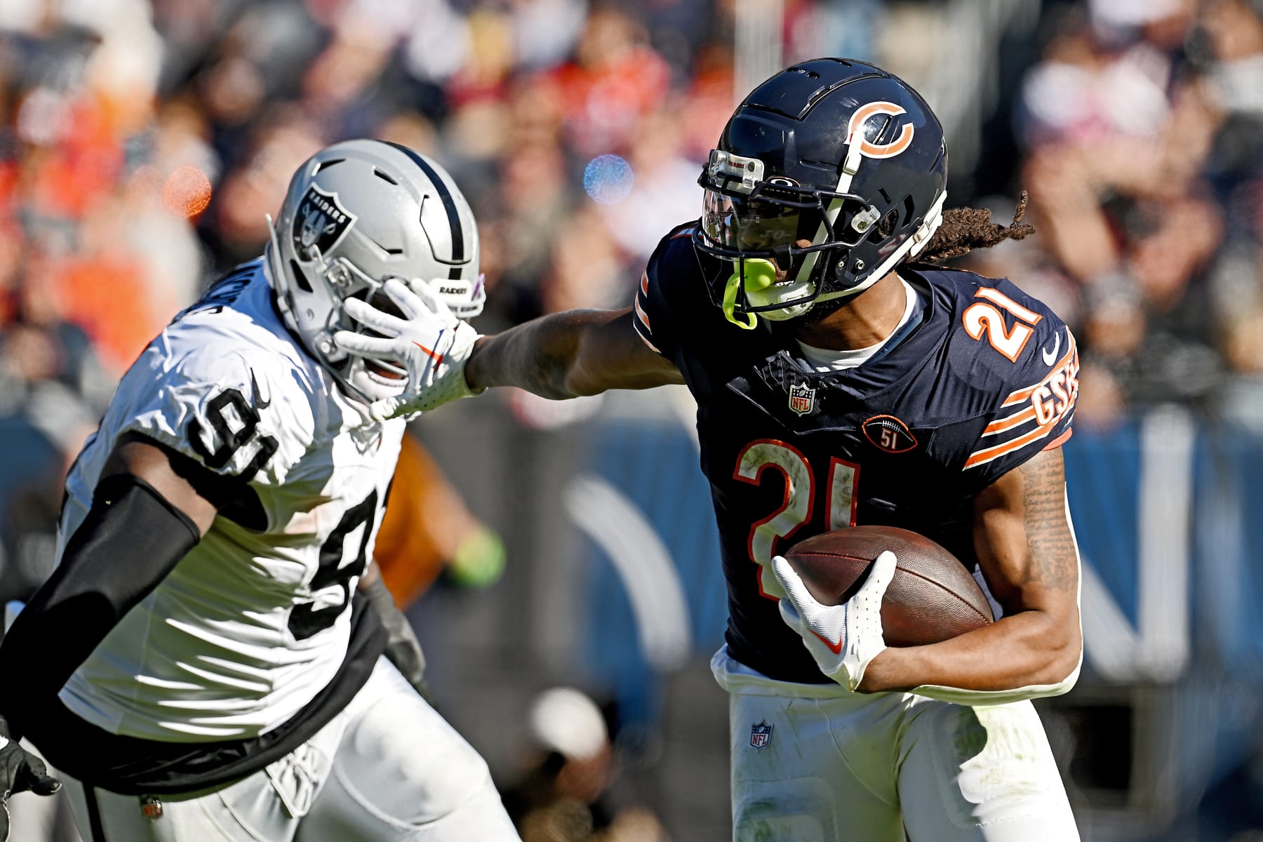 Bears RB  D'Onta Foreman runs past Raiders DL Bilal Nichols