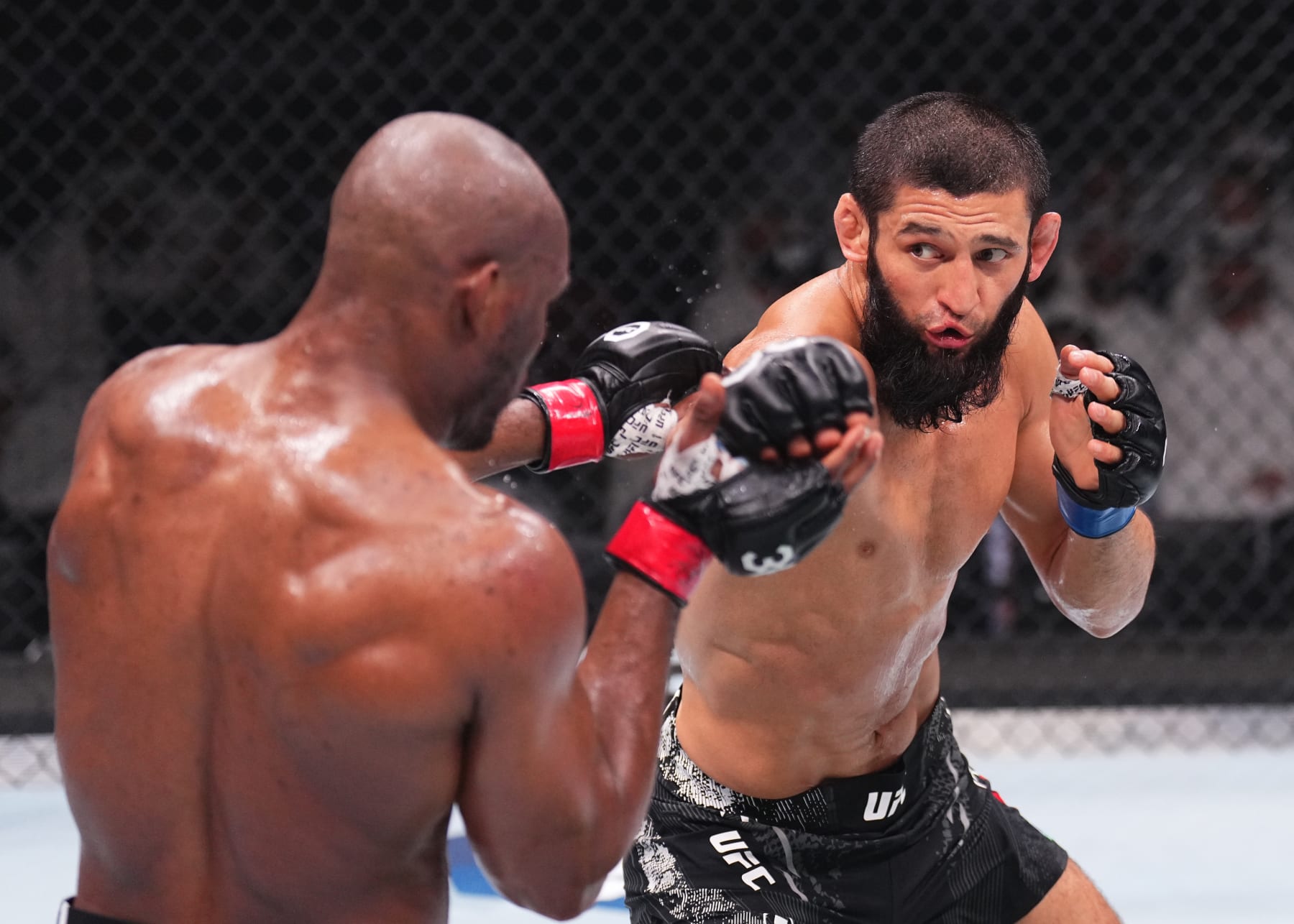 ABU DHABI, UNITED ARAB EMIRATES - OCTOBER 21: (R-L) Khamzat Chimaev of the United Arab Emirates punches Kamaru Usman of Nigeria in a middleweight fight during the UFC 294 event at Etihad Arena on October 21, 2023 in Abu Dhabi, United Arab Emirates. (Photo by Chris Unger/Zuffa LLC via Getty Images)