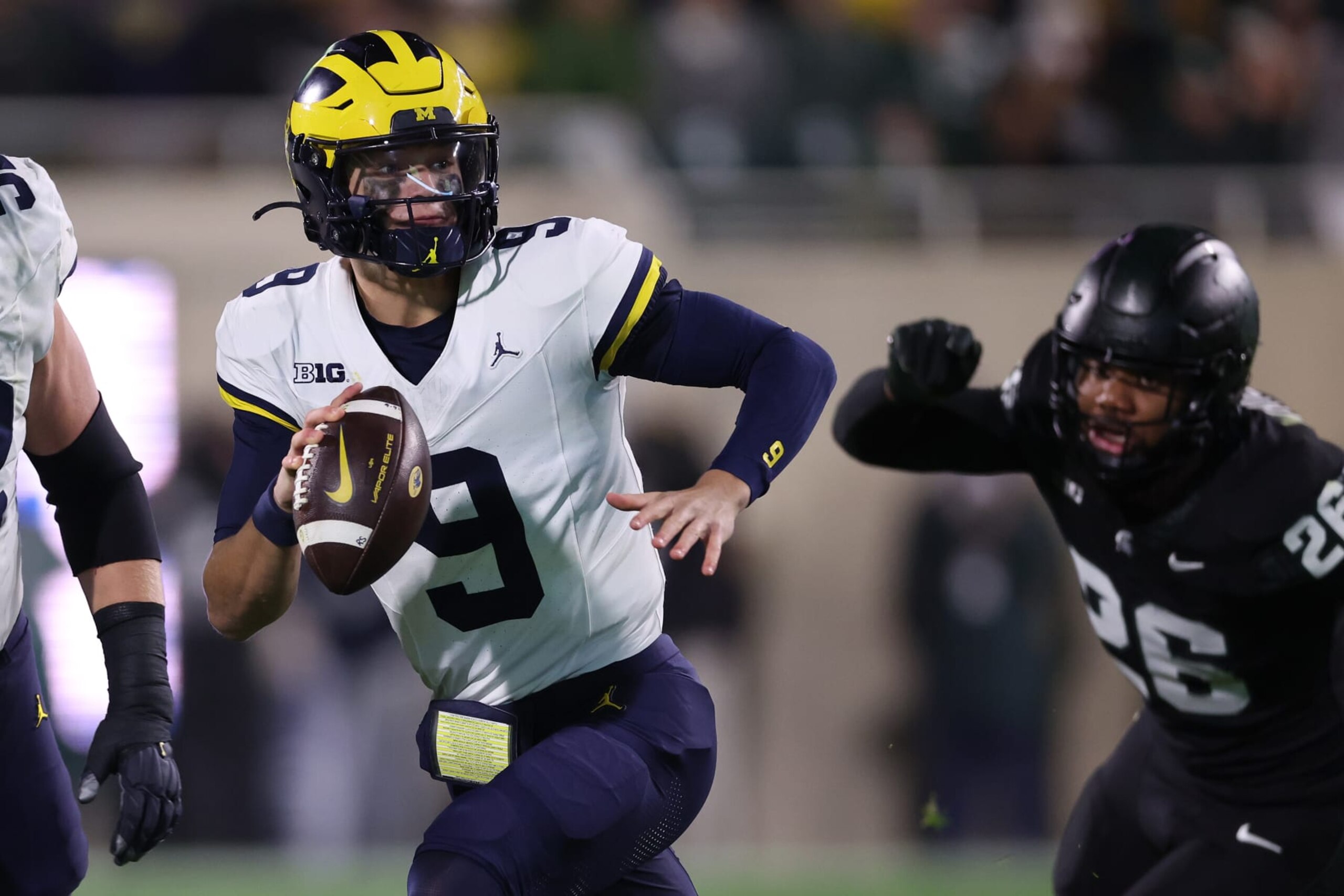 EAST LANSING, MICHIGAN - OCTOBER 21: J.J. McCarthy #9 of the Michigan Wolverines looks to throw a first half pass against the Michigan State Spartans at Spartan Stadium on October 21, 2023 in East Lansing, Michigan. (Photo by Gregory Shamus/Getty Images)