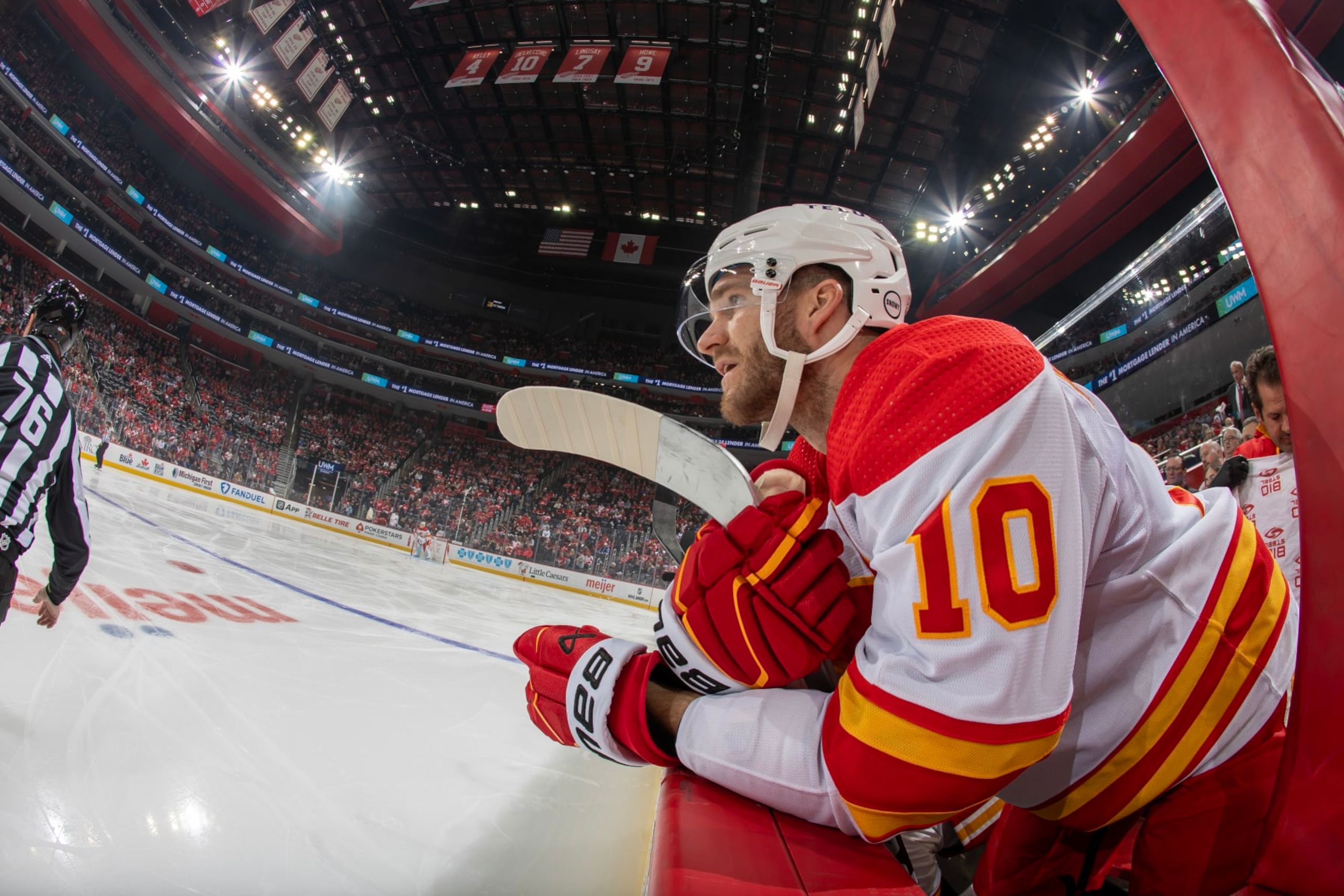 DETROIT, MI - OCTOBER 22: Jonathan Huberdeau #10 of the Calgary Flames watches the action from the bench against the Detroit Red Wings during the first period at Little Caesars Arena on October 22, 2023 in Detroit, Michigan. (Photo by Dave Reginek/NHLI via Getty Images)