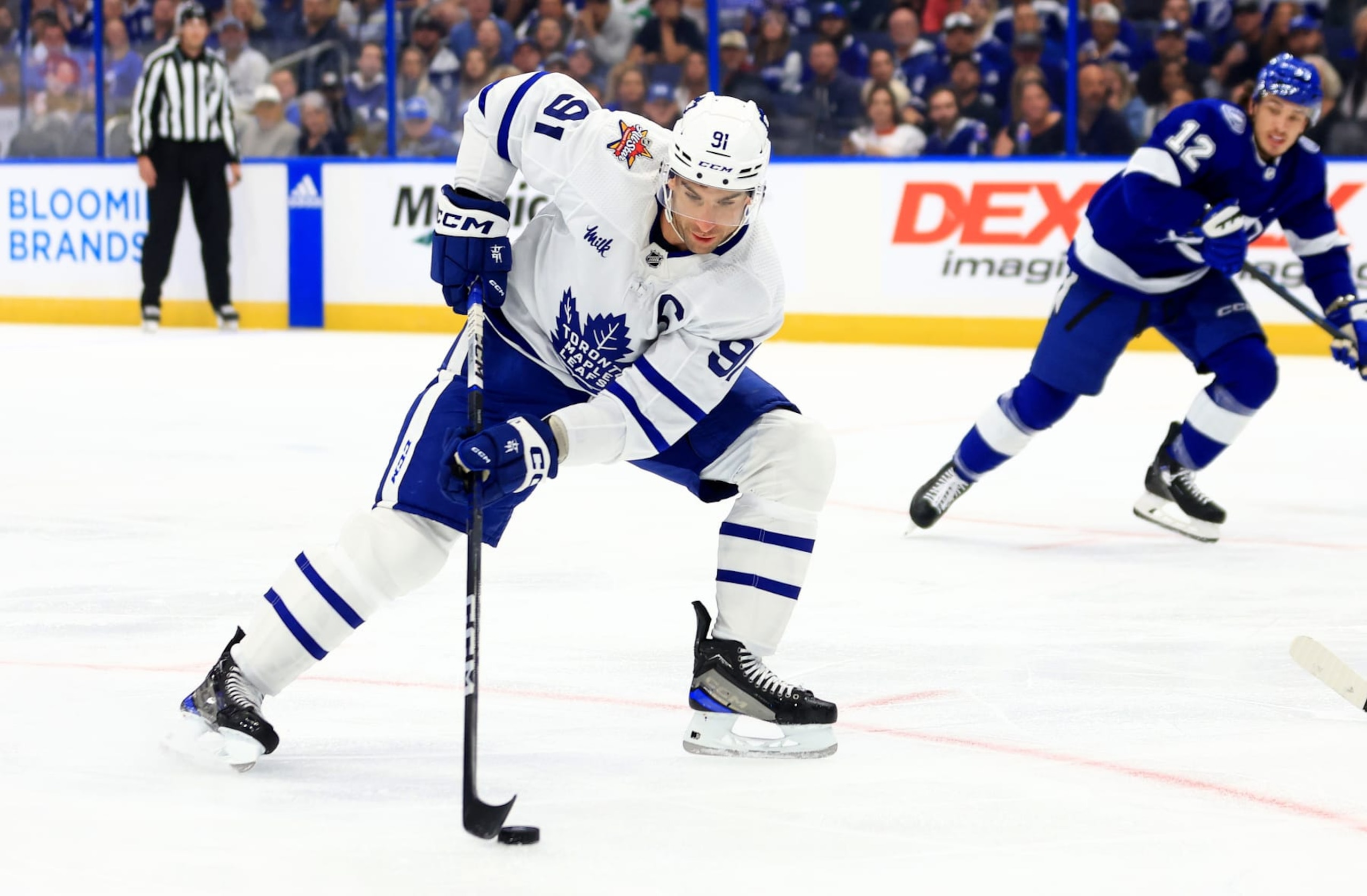 TAMPA, FLORIDA - OCTOBER 21: John Tavares #91 of the Toronto Maple Leafs looks to pass in the first period during a game against the Tampa Bay Lightning at Amalie Arena on October 21, 2023 in Tampa, Florida. (Photo by Mike Ehrmann/Getty Images)