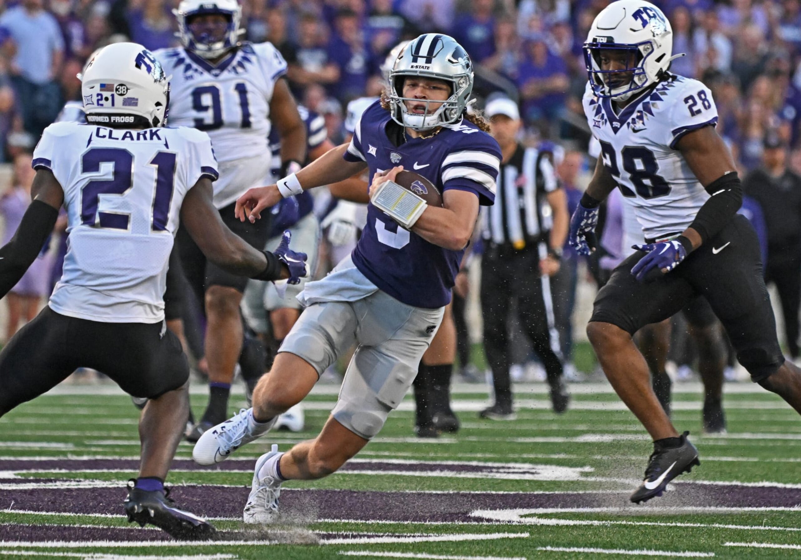 MANHATTAN, KS - OCTOBER 21:  Quarterback Avery Johnson #5 of the Kansas State Wildcats runs up field against safety Bud Clark #21 of the TCU Horned Frogs during the first half at Bill Snyder Family Football Stadium on October 21, 2023 in Manhattan, Kansas. (Photo by Peter Aiken/Getty Images)
