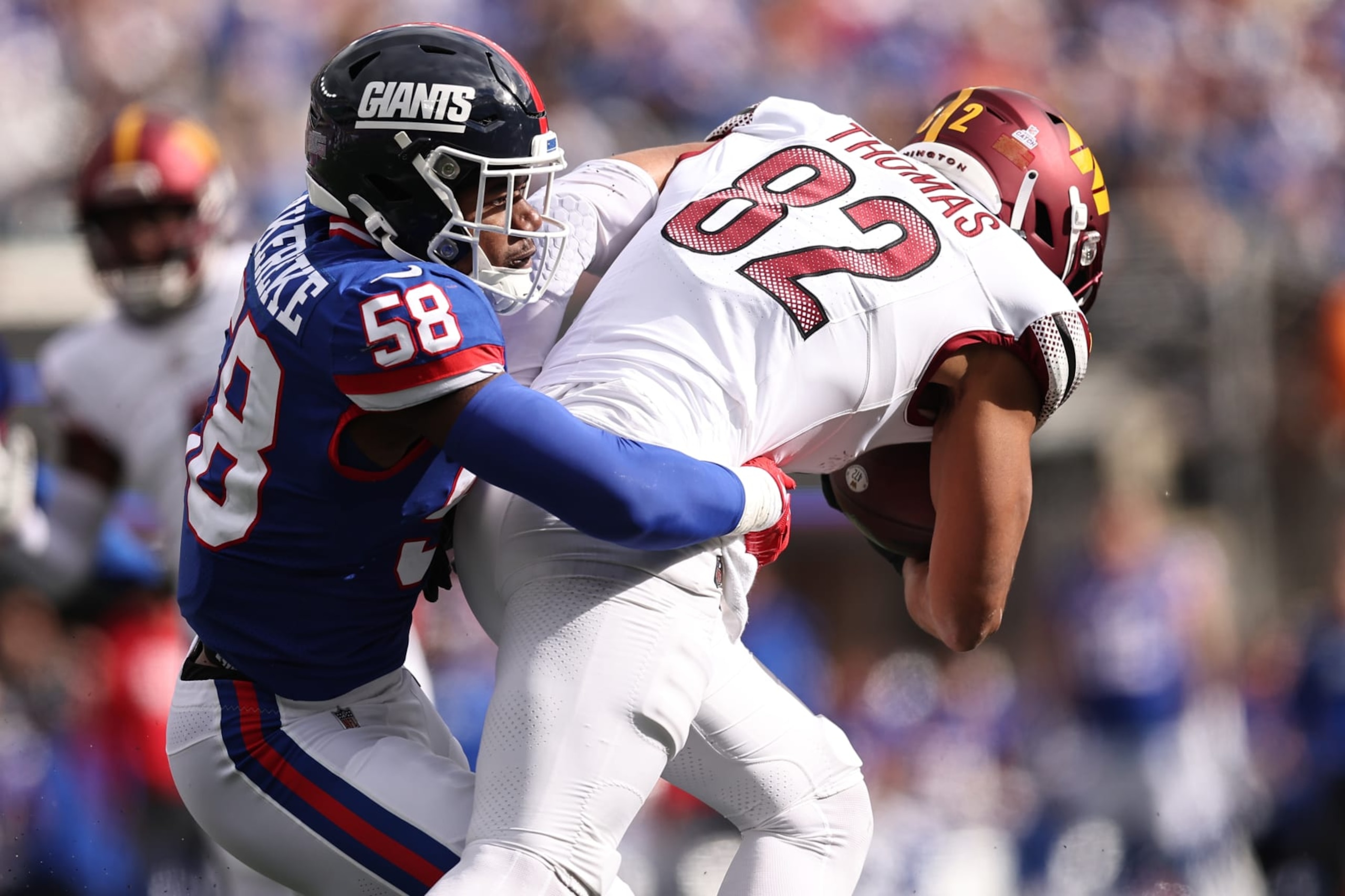 EAST RUTHERFORD, NEW JERSEY - OCTOBER 22: Bobby Okereke #58 of the New York Giants tackles Logan Thomas #82 of the Washington Commanders in the second quarter of the game at MetLife Stadium on October 22, 2023 in East Rutherford, New Jersey. (Photo by Dustin Satloff/Getty Images)