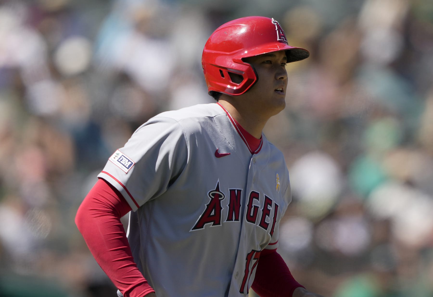 OAKLAND, CALIFORNIA - SEPTEMBER 03: Shohei Ohtani #17 of the Los Angeles Angels trots down to first base after drawing a walk against the Oakland Athletics in the top of the fifth inning at RingCentral Coliseum on September 03, 2023 in Oakland, California. (Photo by Thearon W. Henderson/Getty Images)
