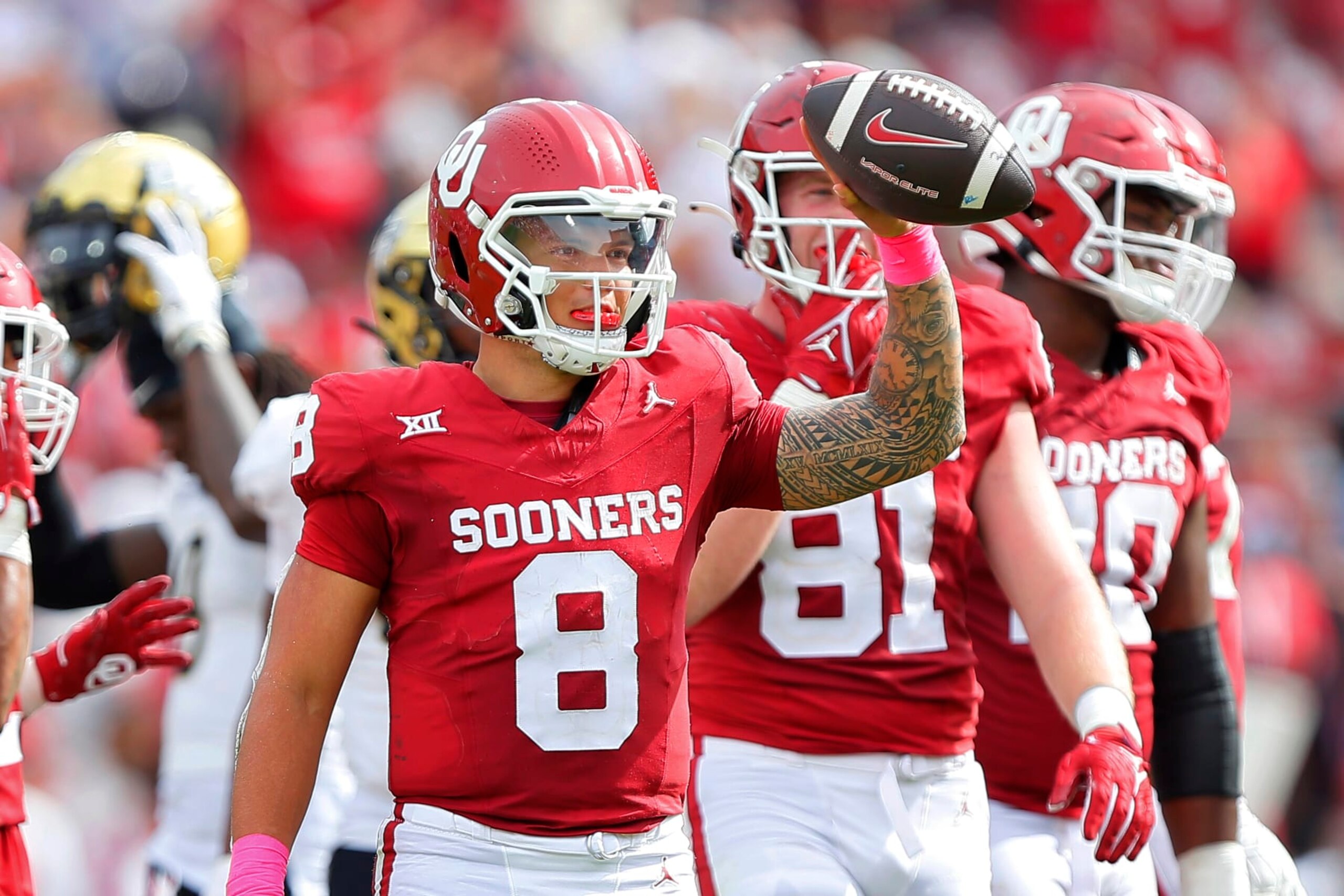 NORMAN, OKLAHOMA - OCTOBER 21:  Quarterback Dillon Gabriel #8 of the Oklahoma Sooners holds up the ball as the clock runs out against the UCF Knights in the fourth quarter at Gaylord Family Oklahoma Memorial Stadium on October 21, 2023 in Norman, Oklahoma.  Oklahoma won 31-29.  (Photo by Brian Bahr/Getty Images)