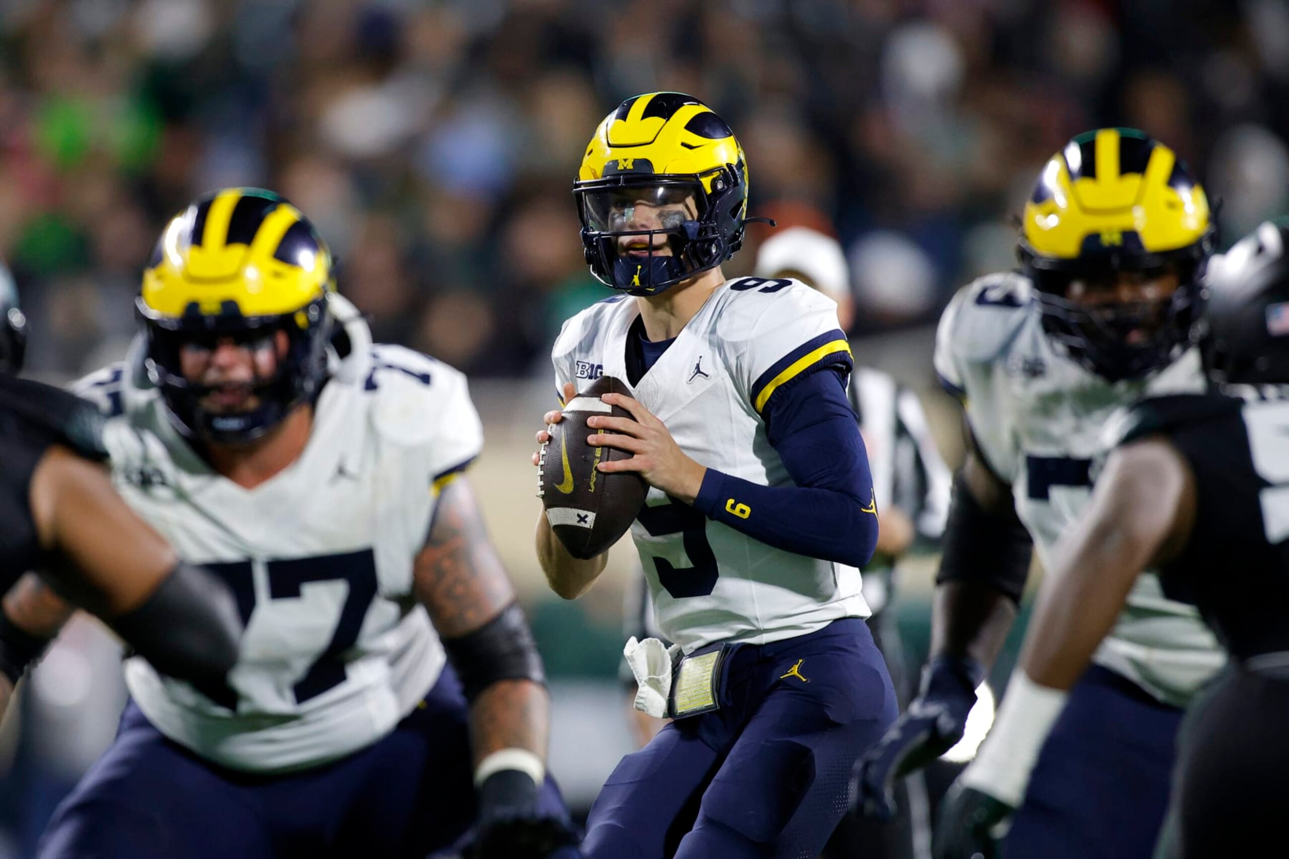 Michigan quarterback J.J. McCarthy (9) looks to throw during an NCAA college football game against Michigan State, Saturday, Oct. 21, 2023, in East Lansing, Mich. (AP Photo/Al Goldis)