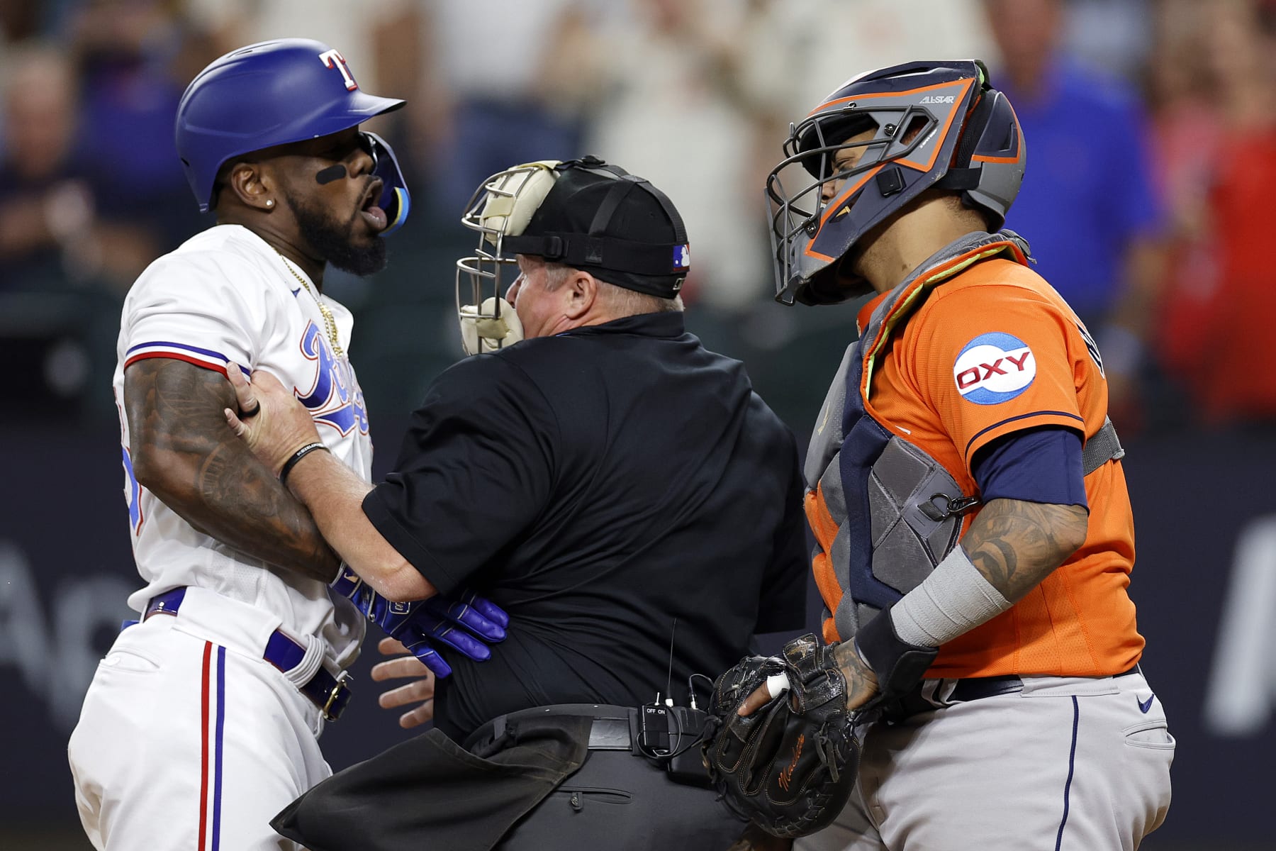 ARLINGTON, TEXAS - OCTOBER 20: Adolis Garcia #53 of the Texas Rangers argues with Martin Maldonado #15 of the Houston Astros after being hit by a pitch by Bryan Abreu #52 of the Houston Astros during the eighth inning in Game Five of the American League Championship Series at Globe Life Field on October 20, 2023 in Arlington, Texas. (Photo by Carmen Mandato/Getty Images)