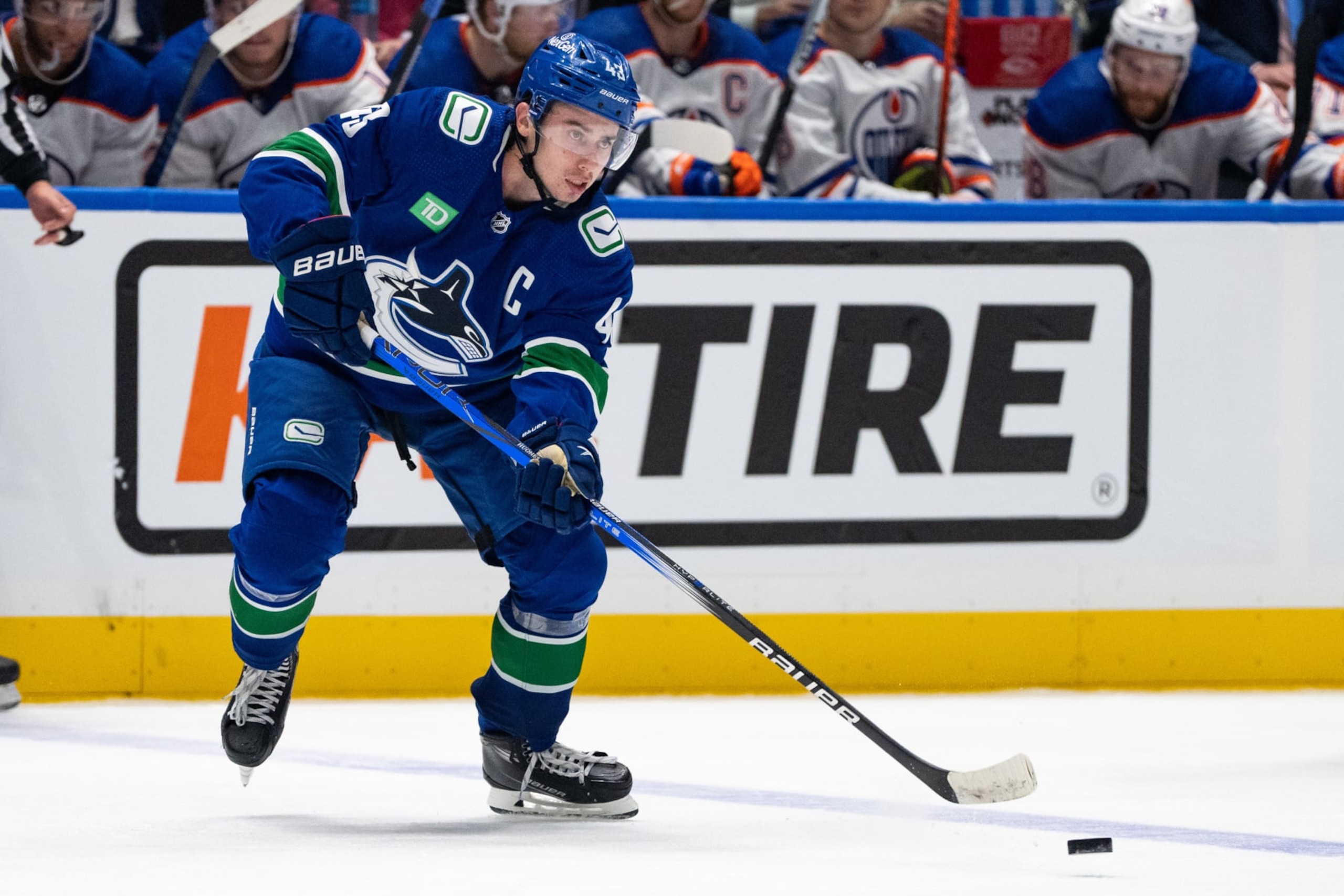 VANCOUVER, BC - OCTOBER 11: Vancouver Canucks defenseman Quinn Hughes (43) passes the puck during the third period of an NHL game against the Edmonton Oilers on October 11, 2023, at the Rogers Arena in Vancouver, B.C. (Photo by Ethan Cairns/Icon Sportswire via Getty Images)