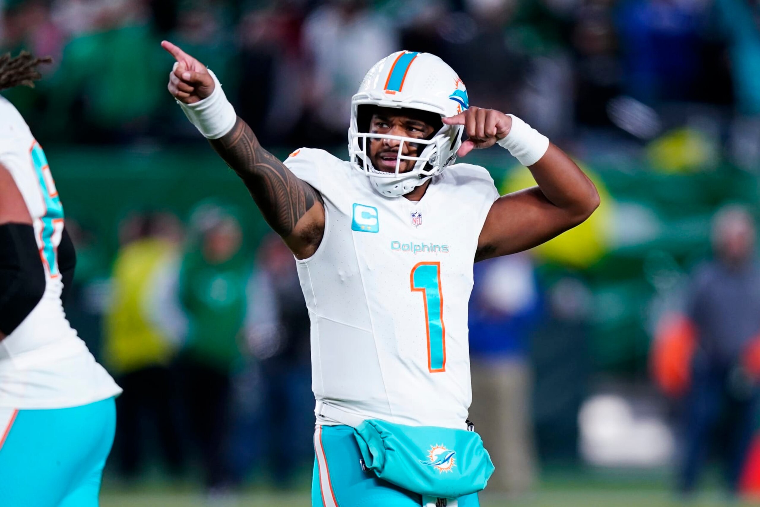 Miami Dolphins quarterback Tua Tagovailoa (1) celebrates a touchdown throw to Dolphins wide receiver Tyreek Hill during the first half of an NFL football game against the Philadelphia Eagles on Sunday, Oct. 22, 2023, in Philadelphia. (AP Photo/Chris Szagola)