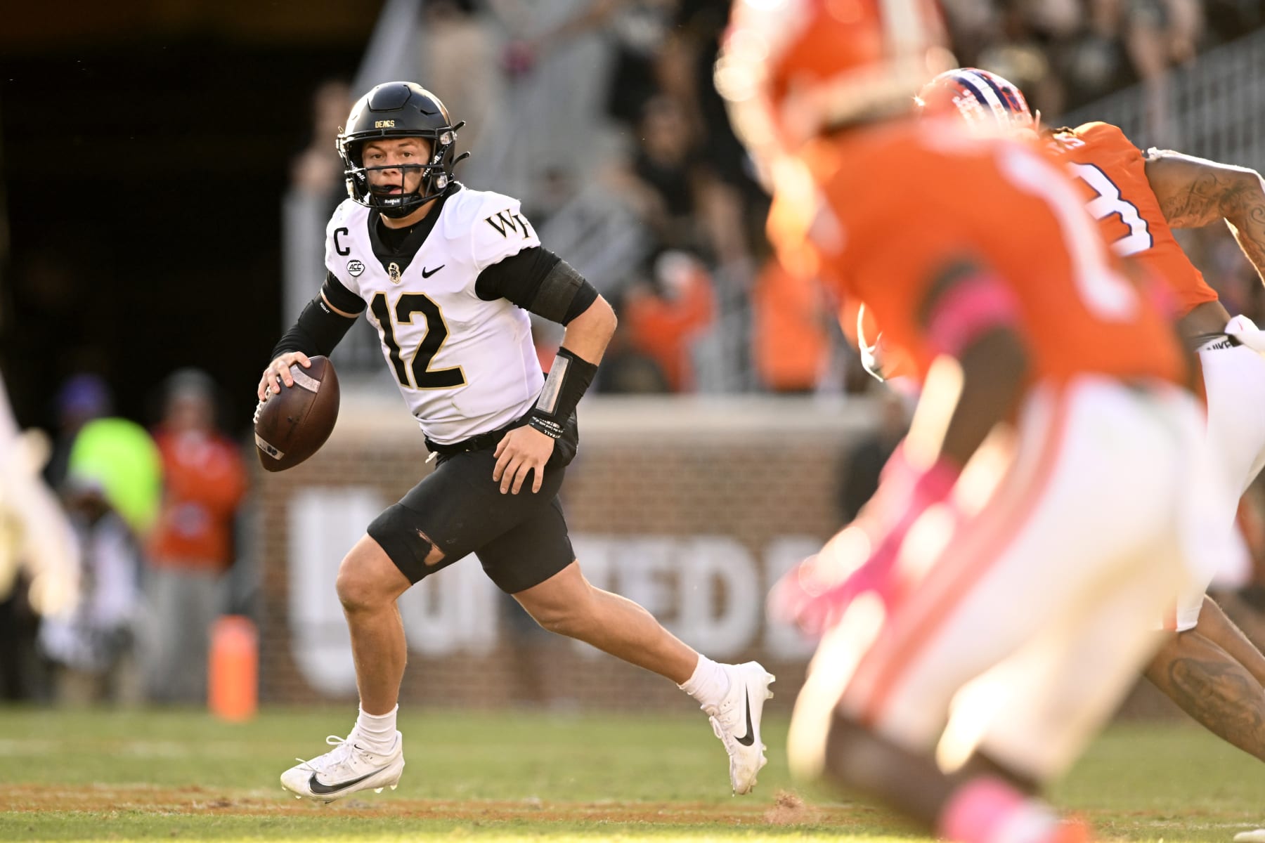 CLEMSON, SOUTH CAROLINA - OCTOBER 07: Mitch Griffis #12 of the Wake Forest Demon Deacons looks for a pass against the Clemson Tigers in the third quarter at Memorial Stadium on October 07, 2023 in Clemson, South Carolina. (Photo by Eakin Howard/Getty Images)