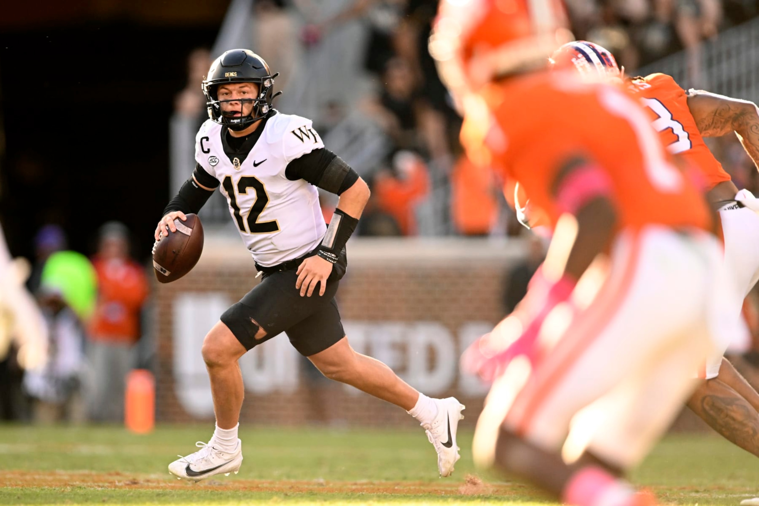 CLEMSON, SOUTH CAROLINA - OCTOBER 07: Mitch Griffis #12 of the Wake Forest Demon Deacons looks for a pass against the Clemson Tigers in the third quarter at Memorial Stadium on October 07, 2023 in Clemson, South Carolina. (Photo by Eakin Howard/Getty Images)