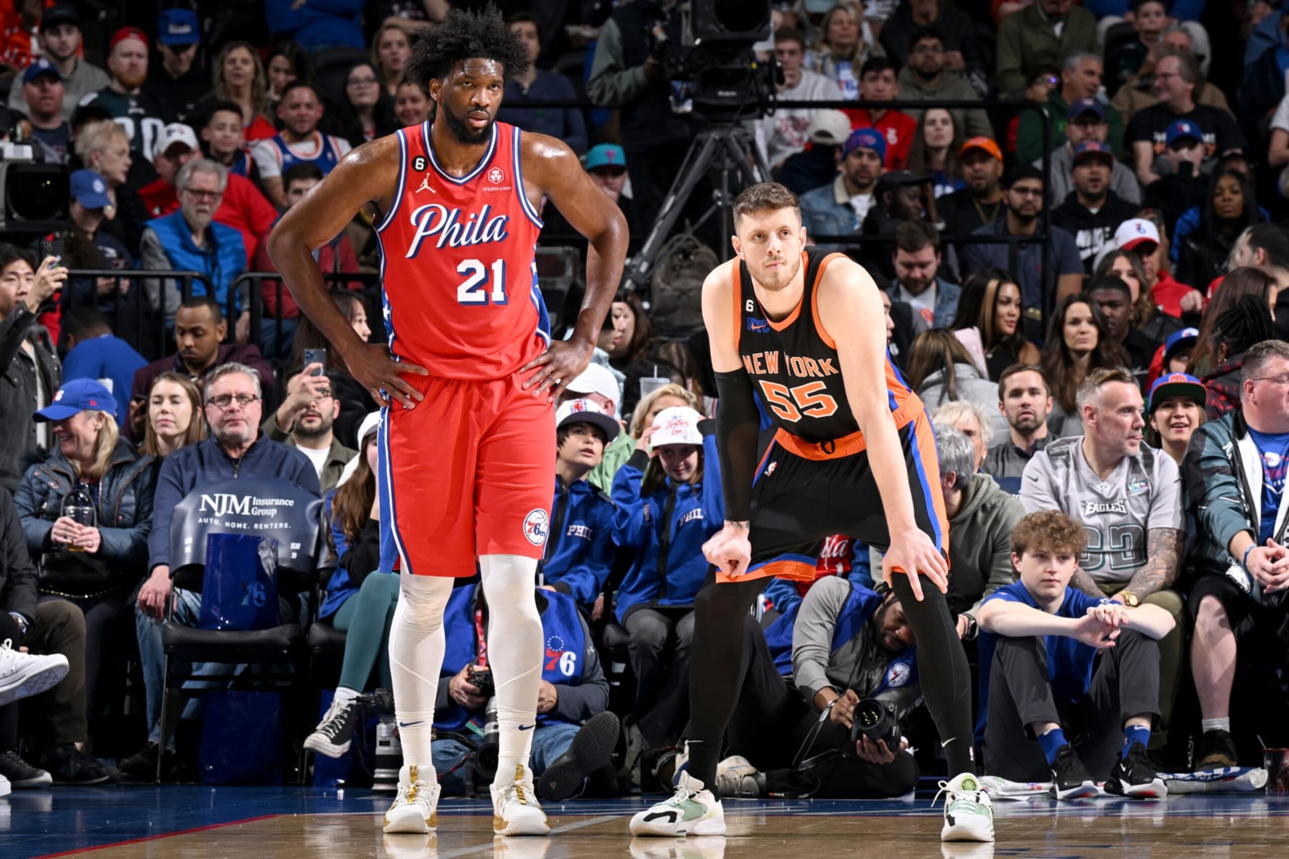 PHILADELPHIA, PA - FEBRUARY 10: Joel Embiid #21 of the Philadelphia 76ers and Isaiah Hartenstein #55 of the New York Knicks look on during the game on February 10, 2023 at the Wells Fargo Center in Philadelphia, Pennsylvania NOTE TO USER: User expressly acknowledges and agrees that, by downloading and/or using this Photograph, user is consenting to the terms and conditions of the Getty Images License Agreement. Mandatory Copyright Notice: Copyright 2023 NBAE (Photo by David Dow/NBAE via Getty Images)