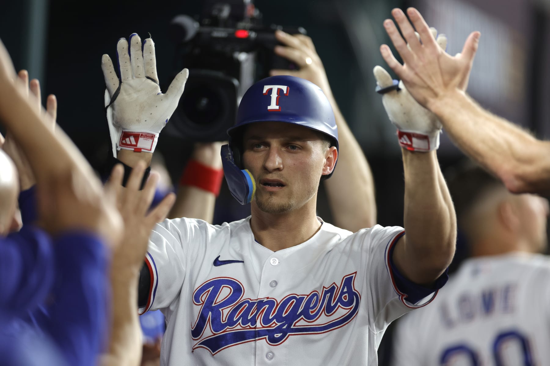 ARLINGTON, TEXAS - OCTOBER 10: Corey Seager #5 of the Texas Rangers celebrates with teammates in the dugout following his solo home run against the Baltimore Orioles during the first inning in Game Three of the Division Series at Globe Life Field on October 10, 2023 in Arlington, Texas. (Photo by Carmen Mandato/Getty Images)