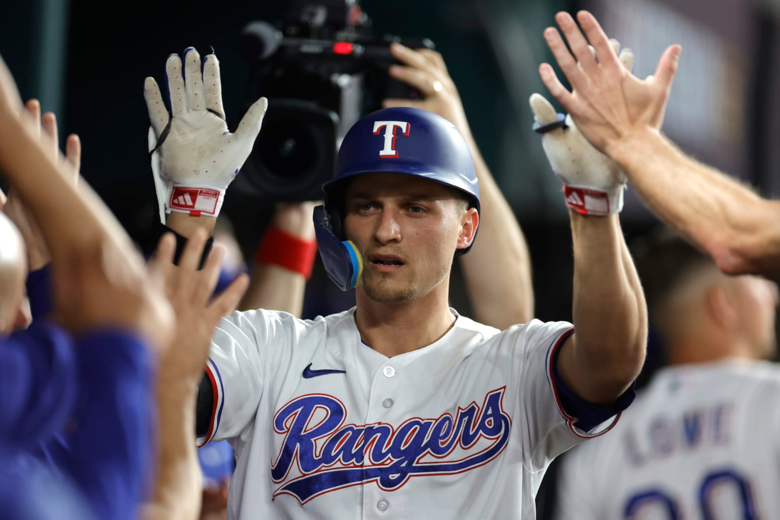 ARLINGTON, TEXAS - OCTOBER 10: Corey Seager #5 of the Texas Rangers celebrates with teammates in the dugout following his solo home run against the Baltimore Orioles during the first inning in Game Three of the Division Series at Globe Life Field on October 10, 2023 in Arlington, Texas. (Photo by Carmen Mandato/Getty Images)