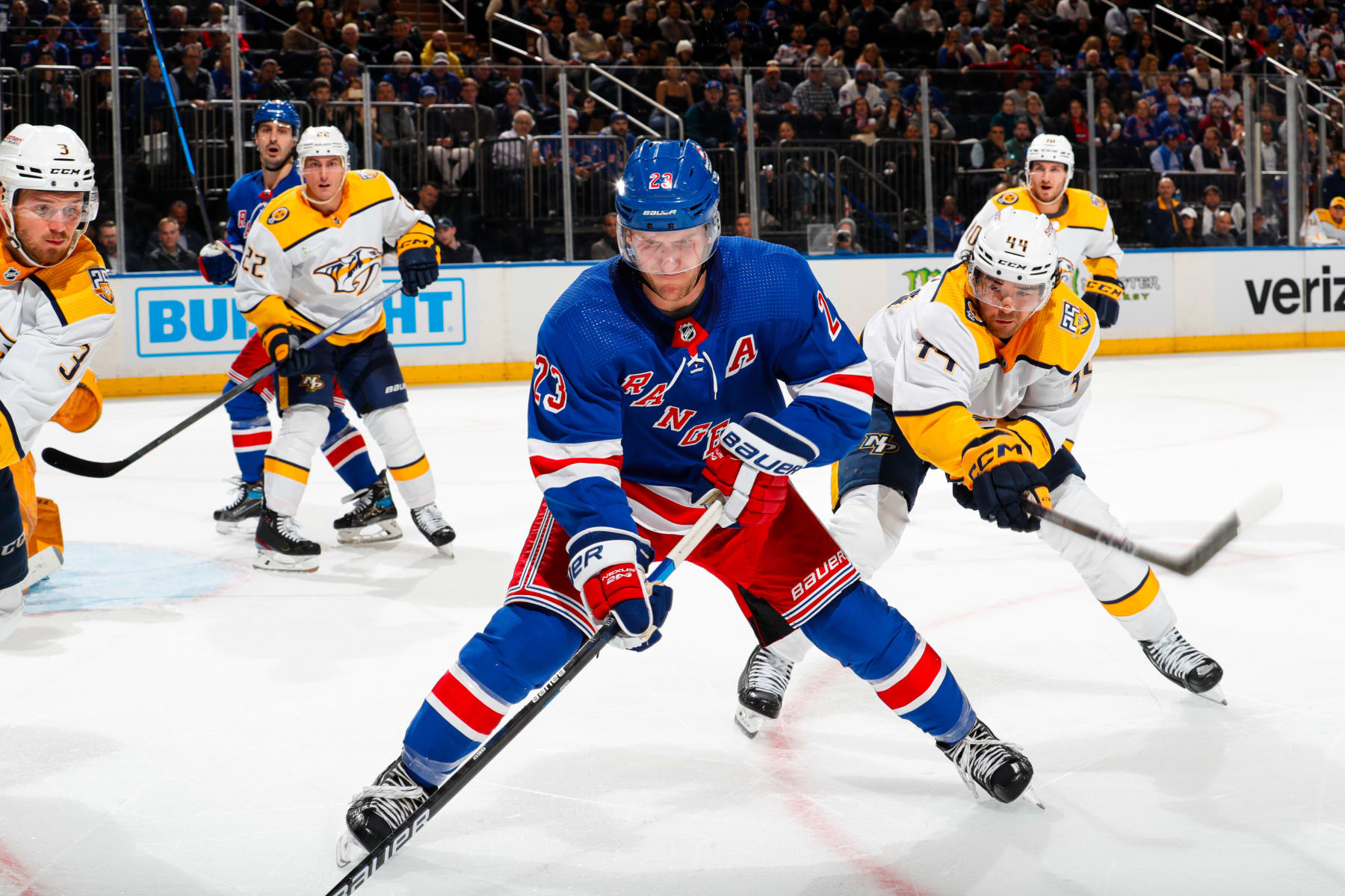 NEW YORK, NEW YORK - OCTOBER 19:  Adam Fox #23 of the New York Rangers skates with the puck against Kiefer Sherwood #44 of the Nashville Predators at Madison Square Garden on October 19, 2023 in New York City. (Photo by Jared Silber/NHLI via Getty Images)