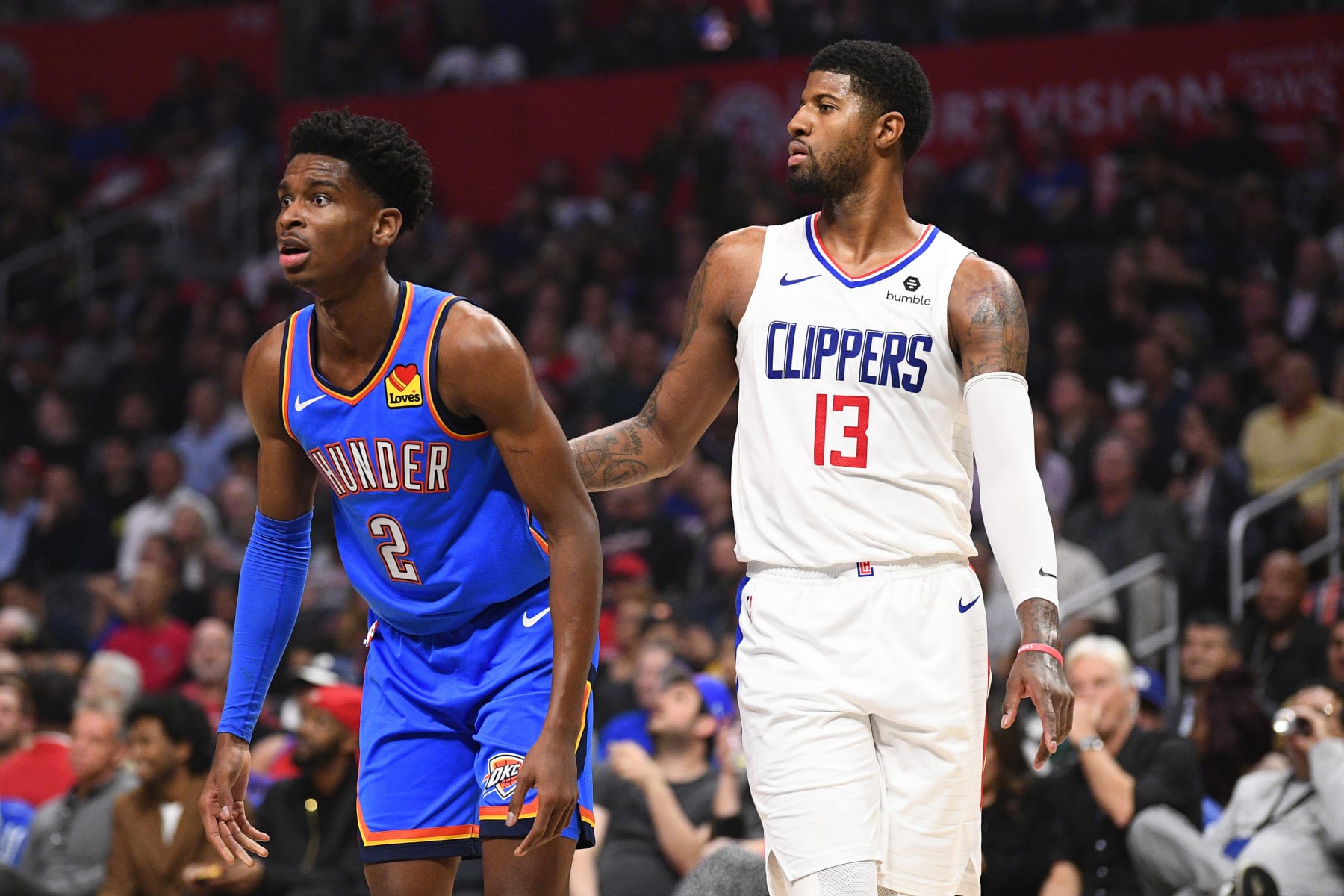 LOS ANGELES, CA - NOVEMBER 18: Oklahoma City Thunder Guard Shai Gilgeous-Alexander (2) and Los Angeles Clippers Guard Paul George (13) and look on during a NBA game between the Oklahoma City Thunder and the Los Angeles Clippers on November 18, 2019 at STAPLES Center in Los Angeles, CA. (Photo by Brian Rothmuller/Icon Sportswire via Getty Images)