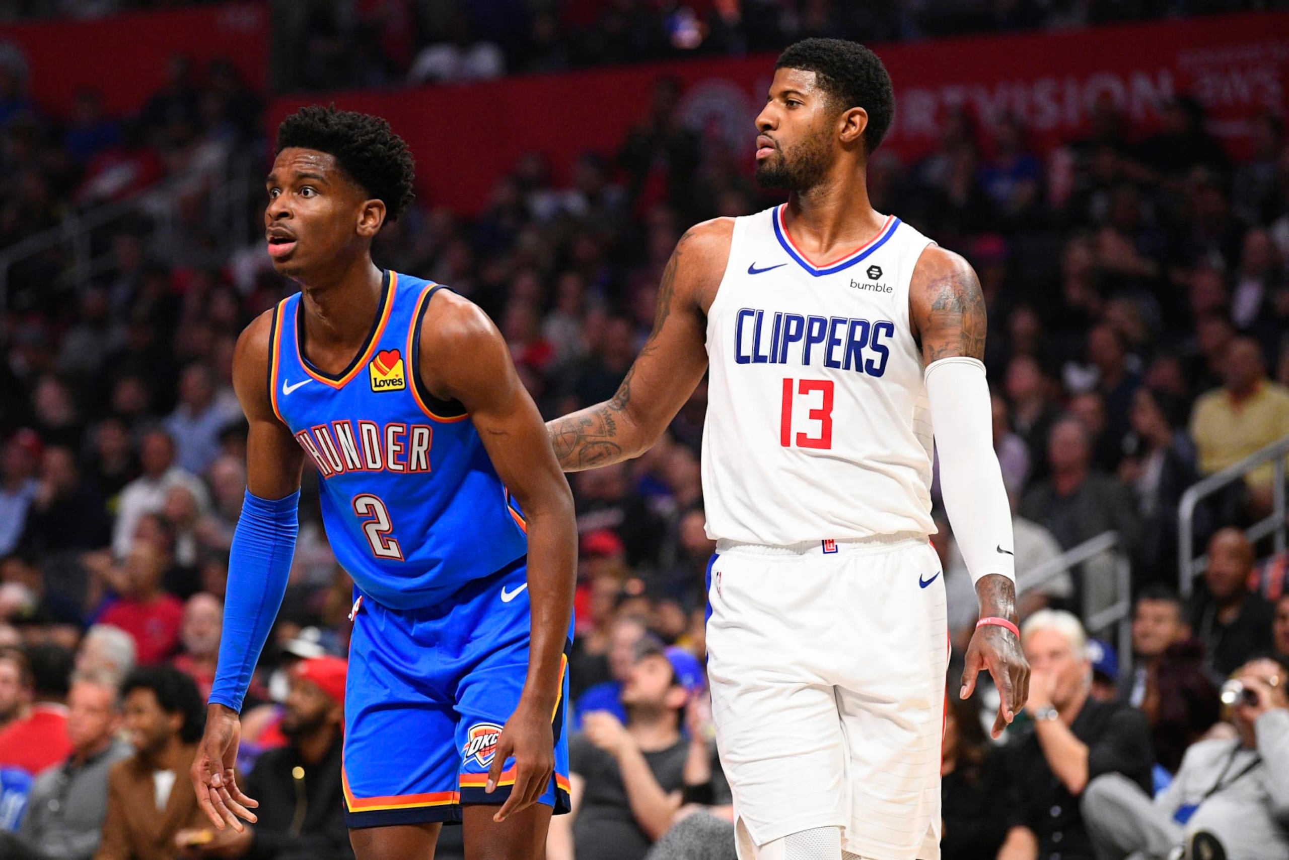 LOS ANGELES, CA - NOVEMBER 18: Oklahoma City Thunder Guard Shai Gilgeous-Alexander (2) and Los Angeles Clippers Guard Paul George (13) and look on during a NBA game between the Oklahoma City Thunder and the Los Angeles Clippers on November 18, 2019 at STAPLES Center in Los Angeles, CA. (Photo by Brian Rothmuller/Icon Sportswire via Getty Images) LOS ANGELES, CA - NOVEMBER 18: Oklahoma City Thunder Guard Shai Gilgeous-Alexander (2) and Los Angeles Clippers Guard Paul George (13) and look on during a NBA game between the Oklahoma City Thunder and the Los Angeles Clippers on November 18, 2019 at STAPLES Center in Los Angeles, CA. (Photo by Brian Rothmuller/Icon Sportswire via Getty Images)