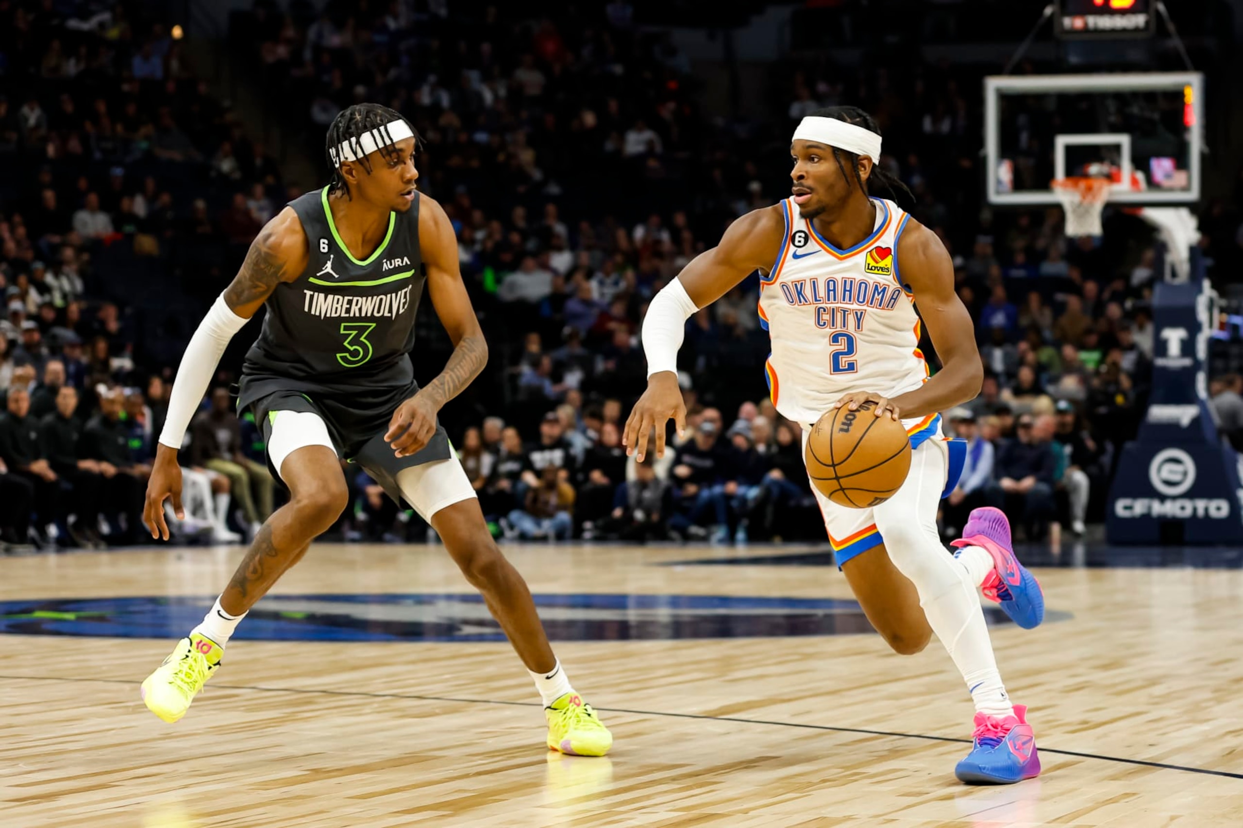 MINNEAPOLIS, MN - DECEMBER 03: Shai Gilgeous-Alexander #2 of the Oklahoma City Thunder dribbles the ball while Jaden McDaniels #3 of the Minnesota Timberwolves defends in the first quarter of the game at Target Center on December 3, 2022 in Minneapolis, Minnesota. The Thunder defeated the Timberwolves 135-128. NOTE TO USER: User expressly acknowledges and agrees that, by downloading and or using this Photograph, user is consenting to the terms and conditions of the Getty Images License Agreement. (Photo by David Berding/Getty Images) MINNEAPOLIS, MN - DECEMBER 03: Shai Gilgeous-Alexander #2 of the Oklahoma City Thunder dribbles the ball while Jaden McDaniels #3 of the Minnesota Timberwolves defends in the first quarter of the game at Target Center on December 3, 2022 in Minneapolis, Minnesota. The Thunder defeated the Timberwolves 135-128. NOTE TO USER: User expressly acknowledges and agrees that, by downloading and or using this Photograph, user is consenting to the terms and conditions of the Getty Images License Agreement. (Photo by David Berding/Getty Images)