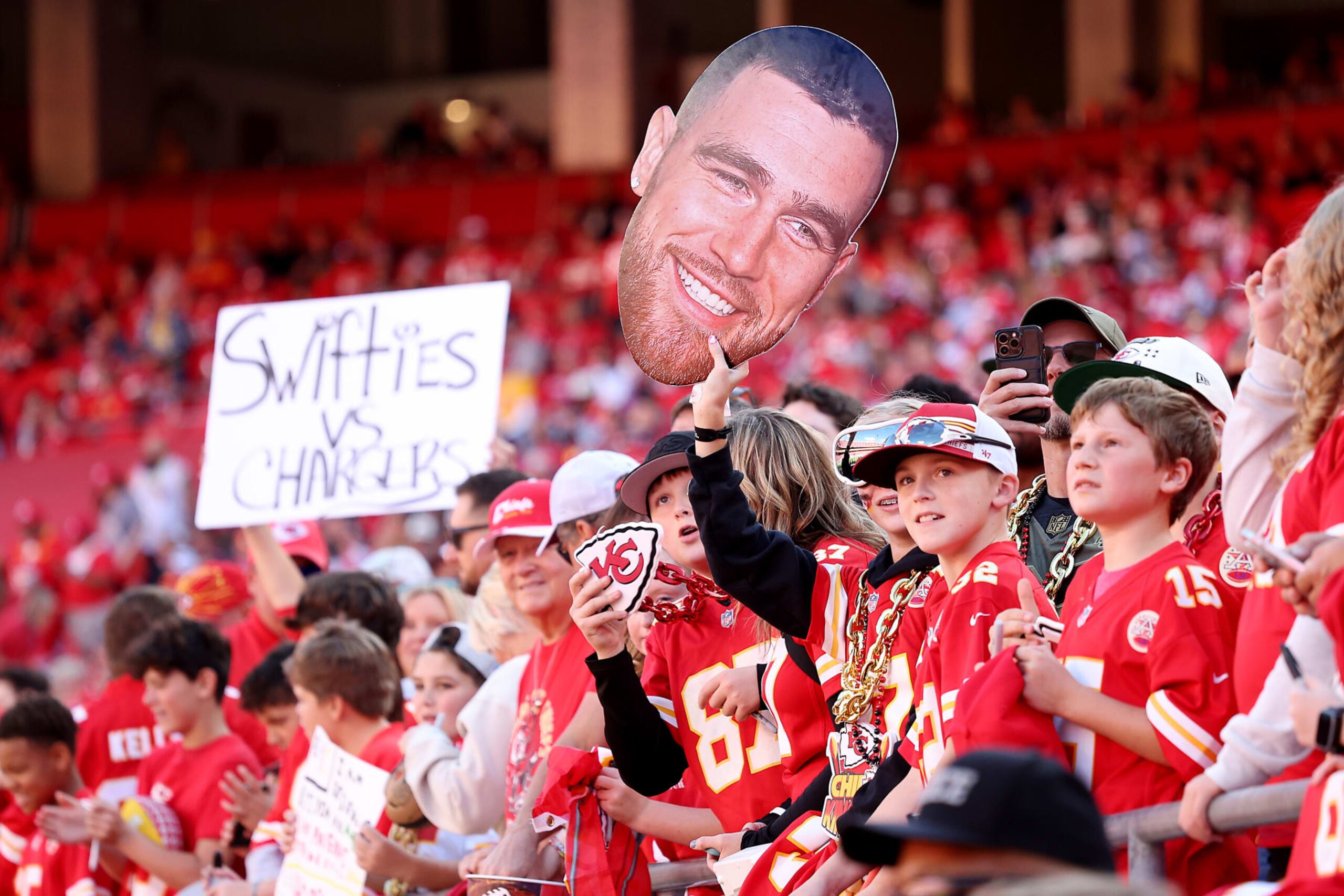 KANSAS CITY, MISSOURI - OCTOBER 22: Kansas City Chiefs fans hold a Travis Kelce #87 sign before the game against the Los Angeles Chargers at GEHA Field at Arrowhead Stadium on October 22, 2023 in Kansas City, Missouri. (Photo by Jamie Squire/Getty Images)