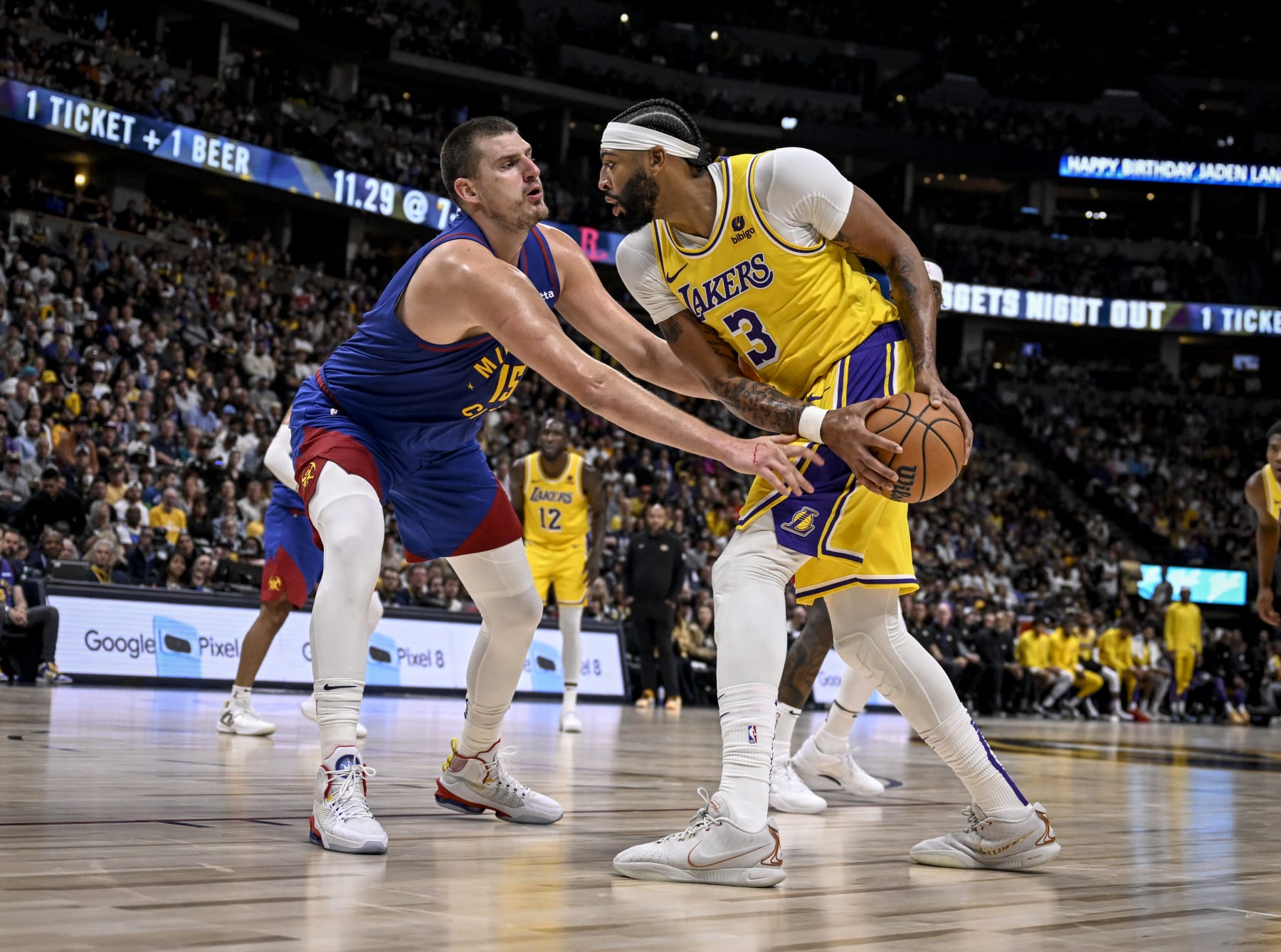 DENVER, CO - OCTOBER 24: Nikola Jokic (15) of the Denver Nuggets locks up Anthony Davis (3) of the Los Angeles Lakers during the third quarter at Ball Arena in Denver on Tuesday, October 24, 2023. (Photo by AAron Ontiveroz/The Denver Post)