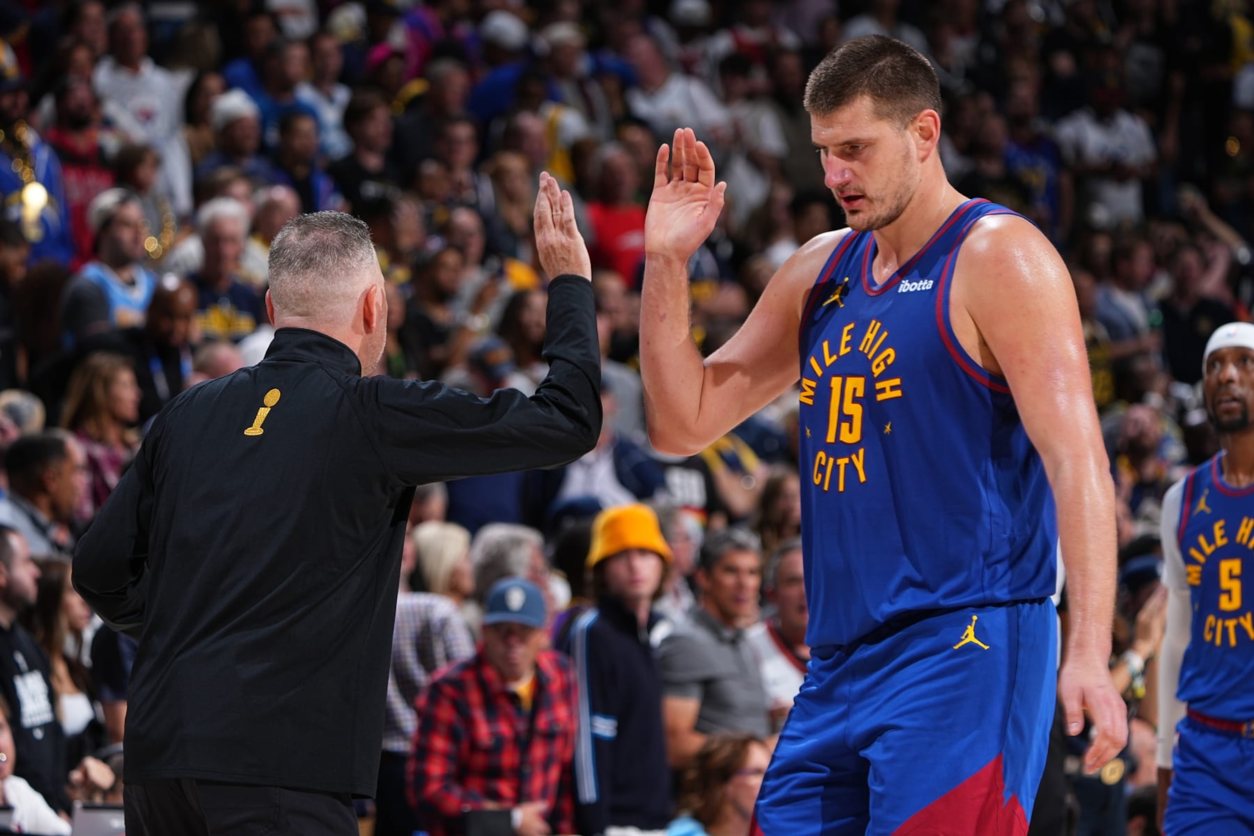 DENVER, CO - OCTOBER 24: Michael Malone and Nikola Jokic #15 of the Denver Nuggets shake hands against the Los Angeles Lakers on October 24, 2023 at the Ball Arena in Denver, Colorado. NOTE TO USER: User expressly acknowledges and agrees that, by downloading and/or using this Photograph, user is consenting to the terms and conditions of the Getty Images License Agreement. Mandatory Copyright Notice: Copyright 2023 NBAE (Photo by Garrett Ellwood/NBAE via Getty Images)